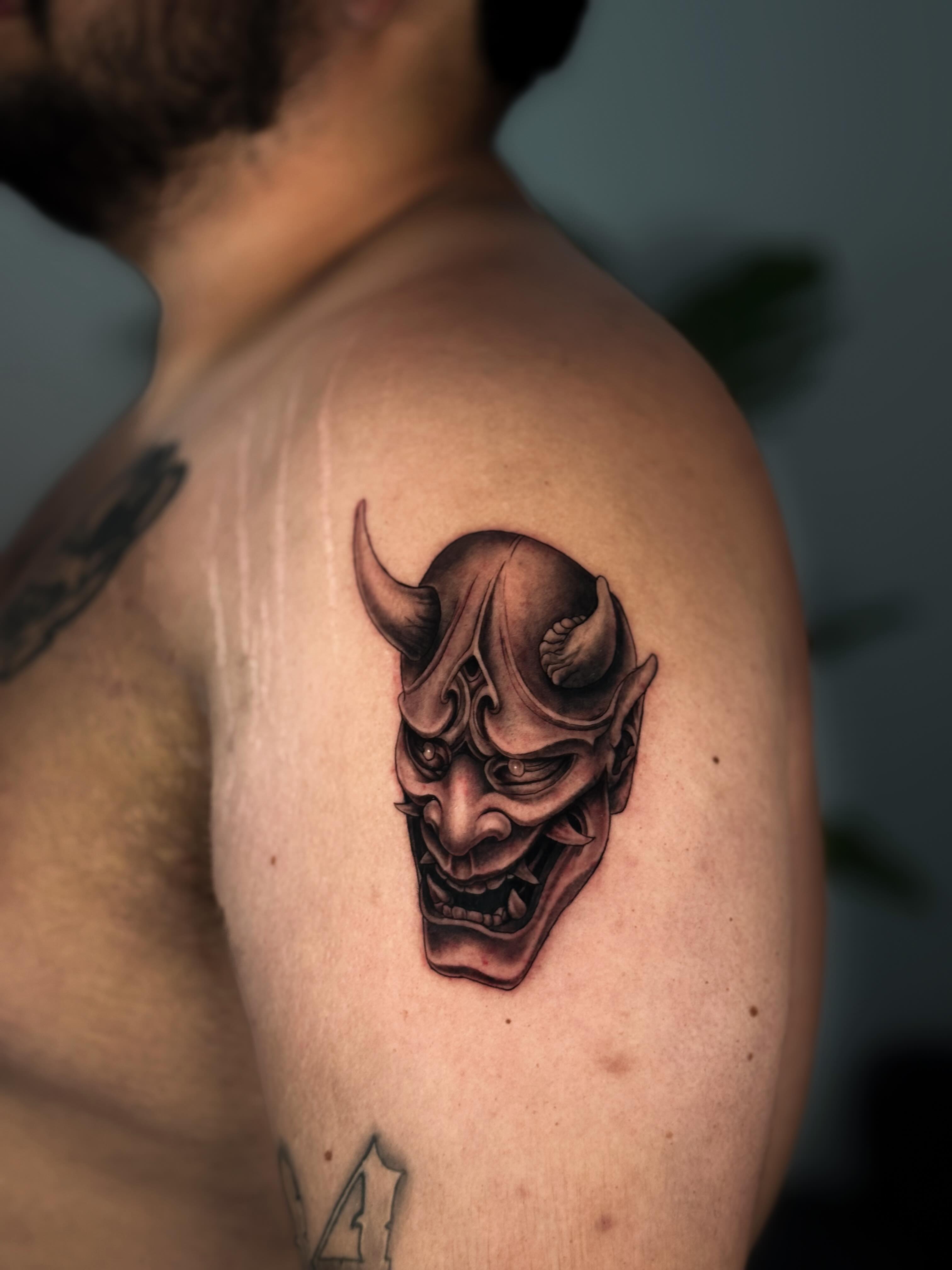 Demon mask realism tattoo on the shoulder by Kai, Charlotte, North Carolina