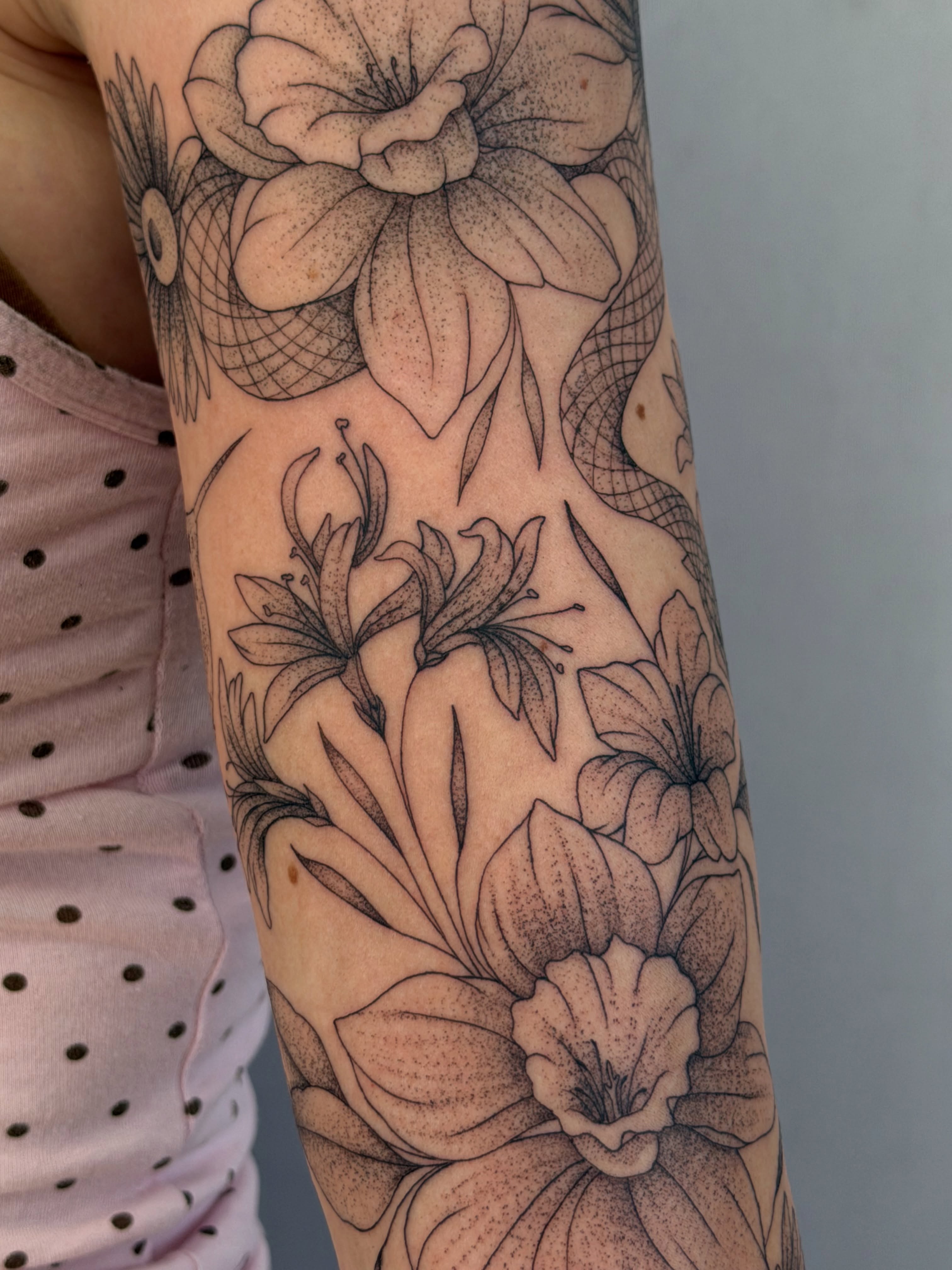 Floral arrangement dotwork tattoo on the forearm by Henesee Parfitt