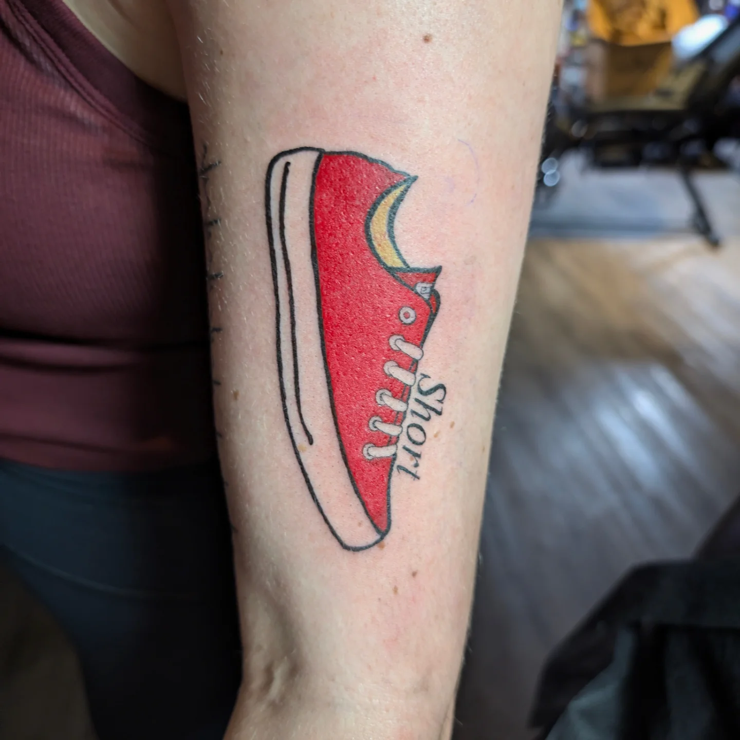Red sneaker dotwork tattoo on the forearm by Jo Xylo - Minneapolis Tattoo Artist, Minneapolis, Minnesota