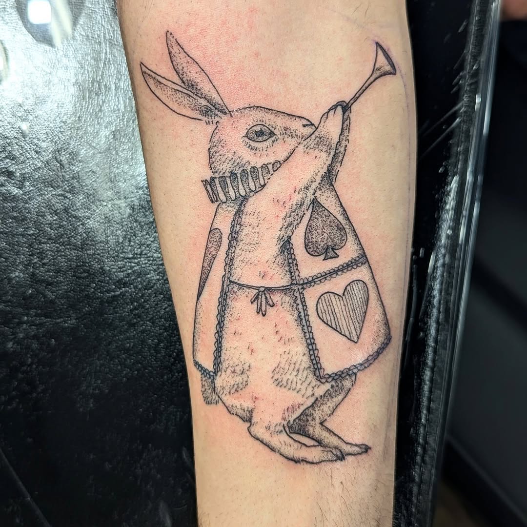 White rabbit playing trumpet fine line tattoo on the forearm by DONEL 📍Denver