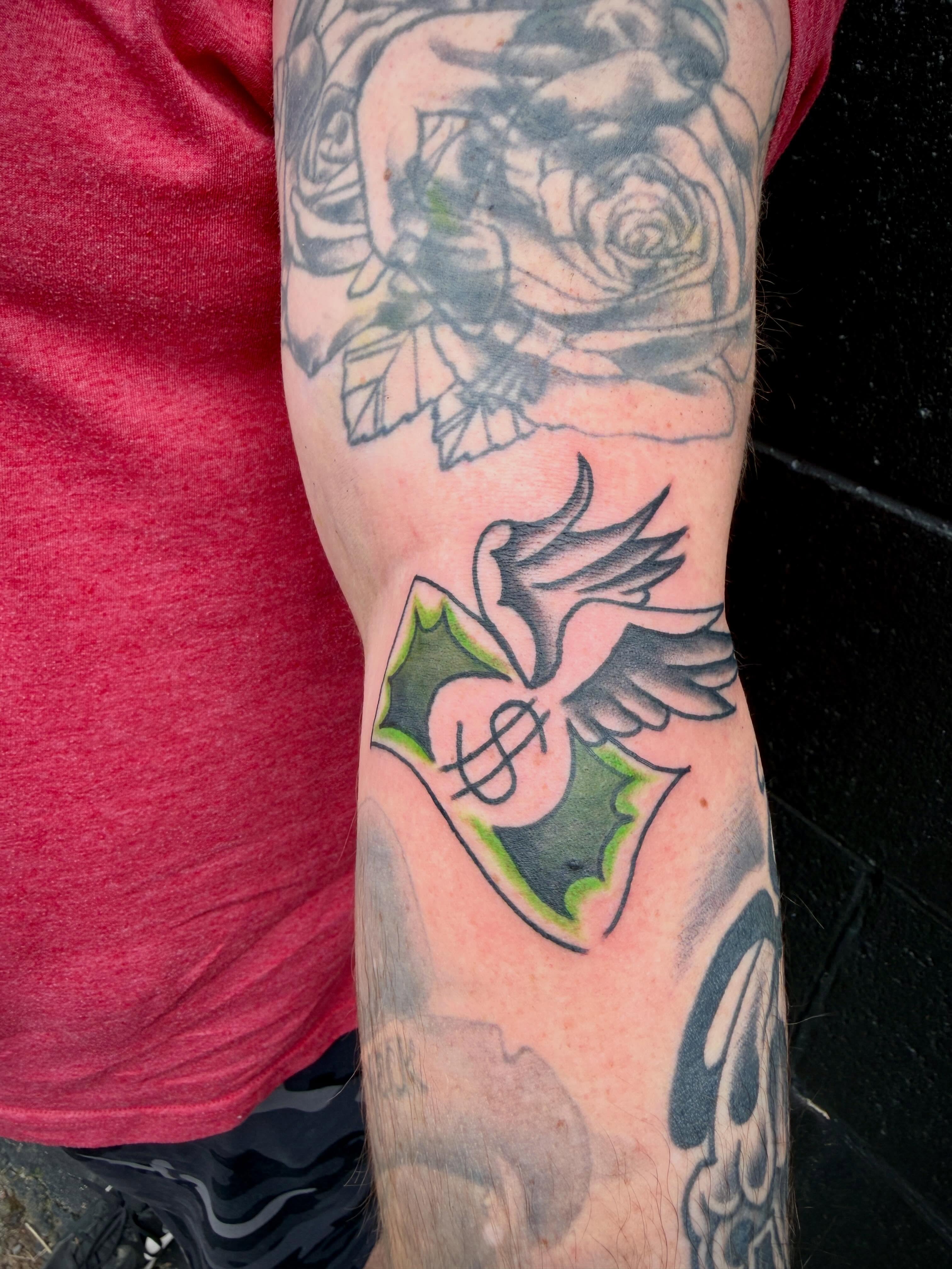 Bird and holly American traditional tattoo on the forearm by Ali Calis
