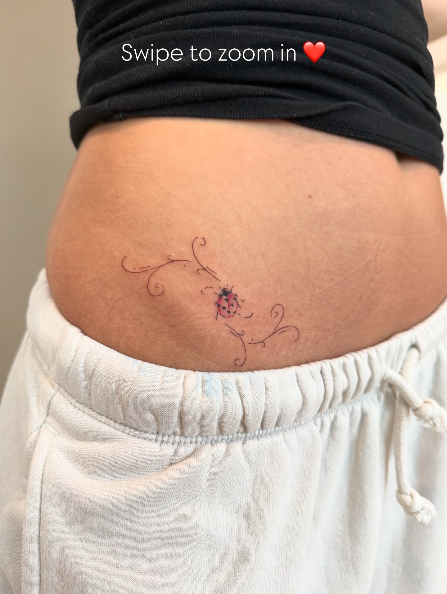 Ladybug fine line tattoo on the torso by Fine Line Tattoos