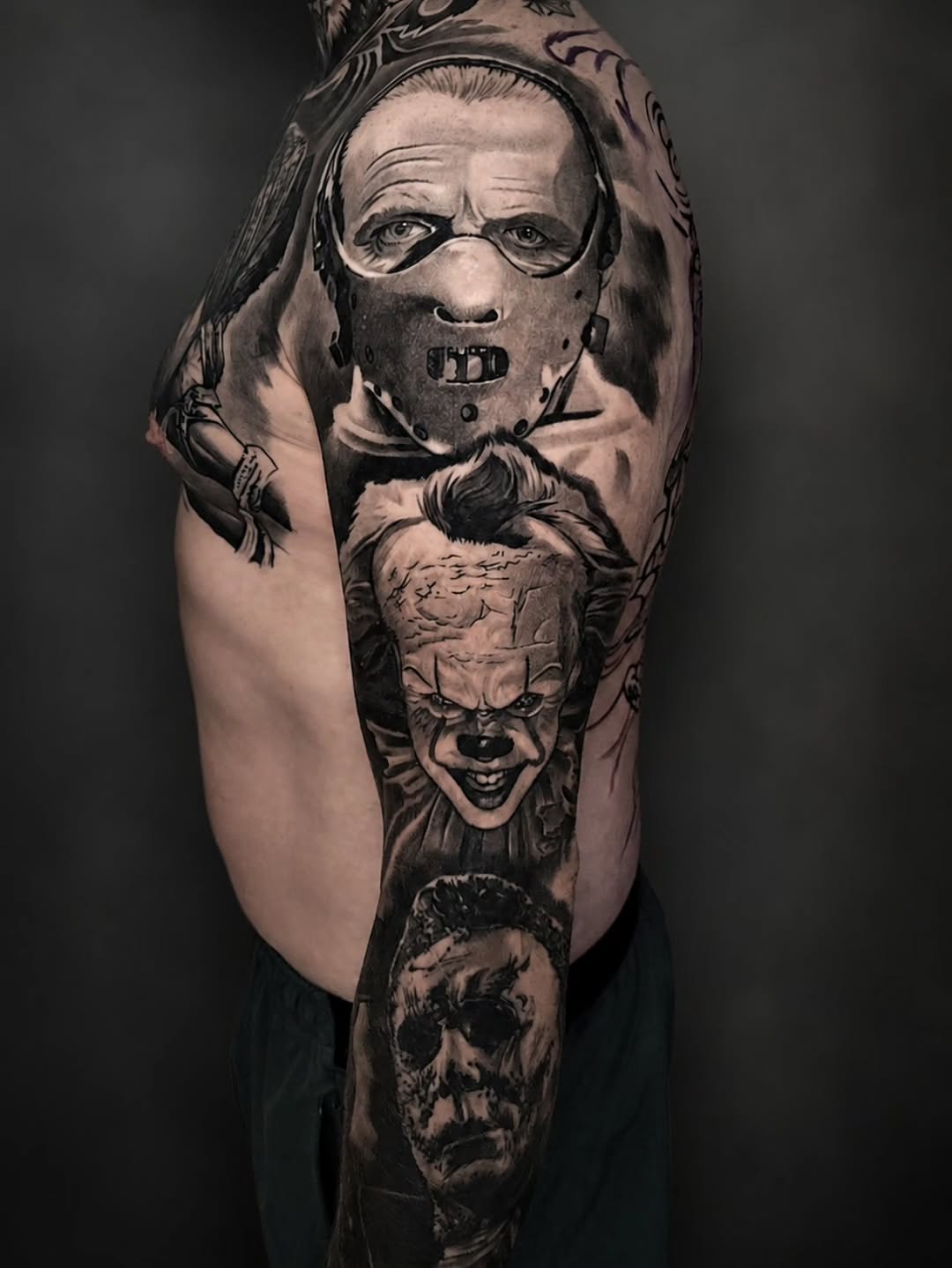 Horror movie characters sleeve realism tattoo on the upper arm by Lukasz Olszanski