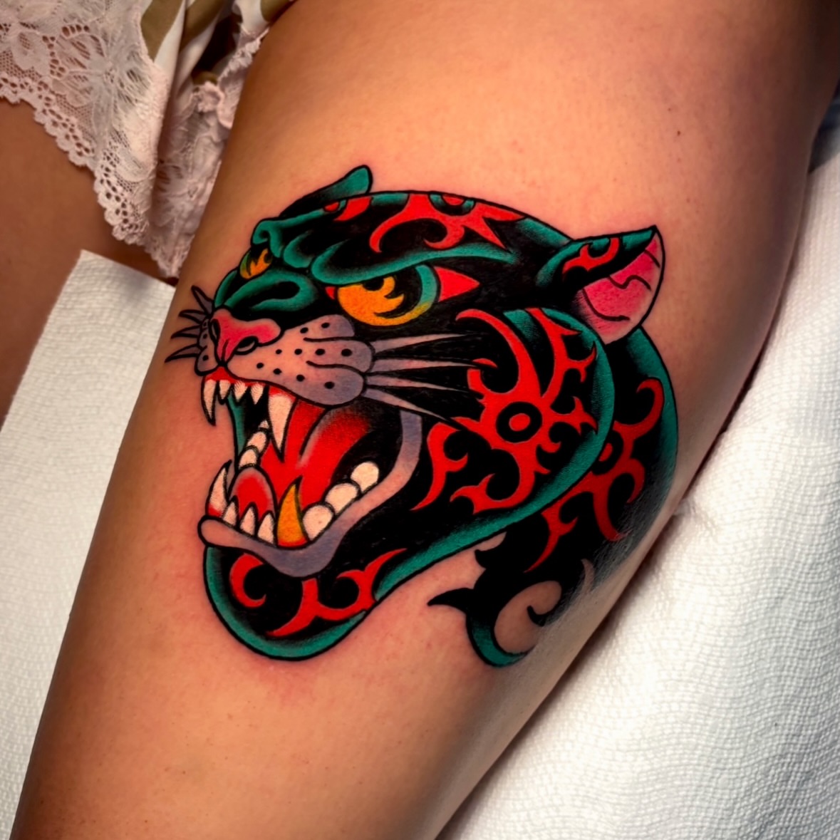 Roaring jaguar American traditional tattoo on the thigh by Mickey Putillo, Charlotte, North Carolina