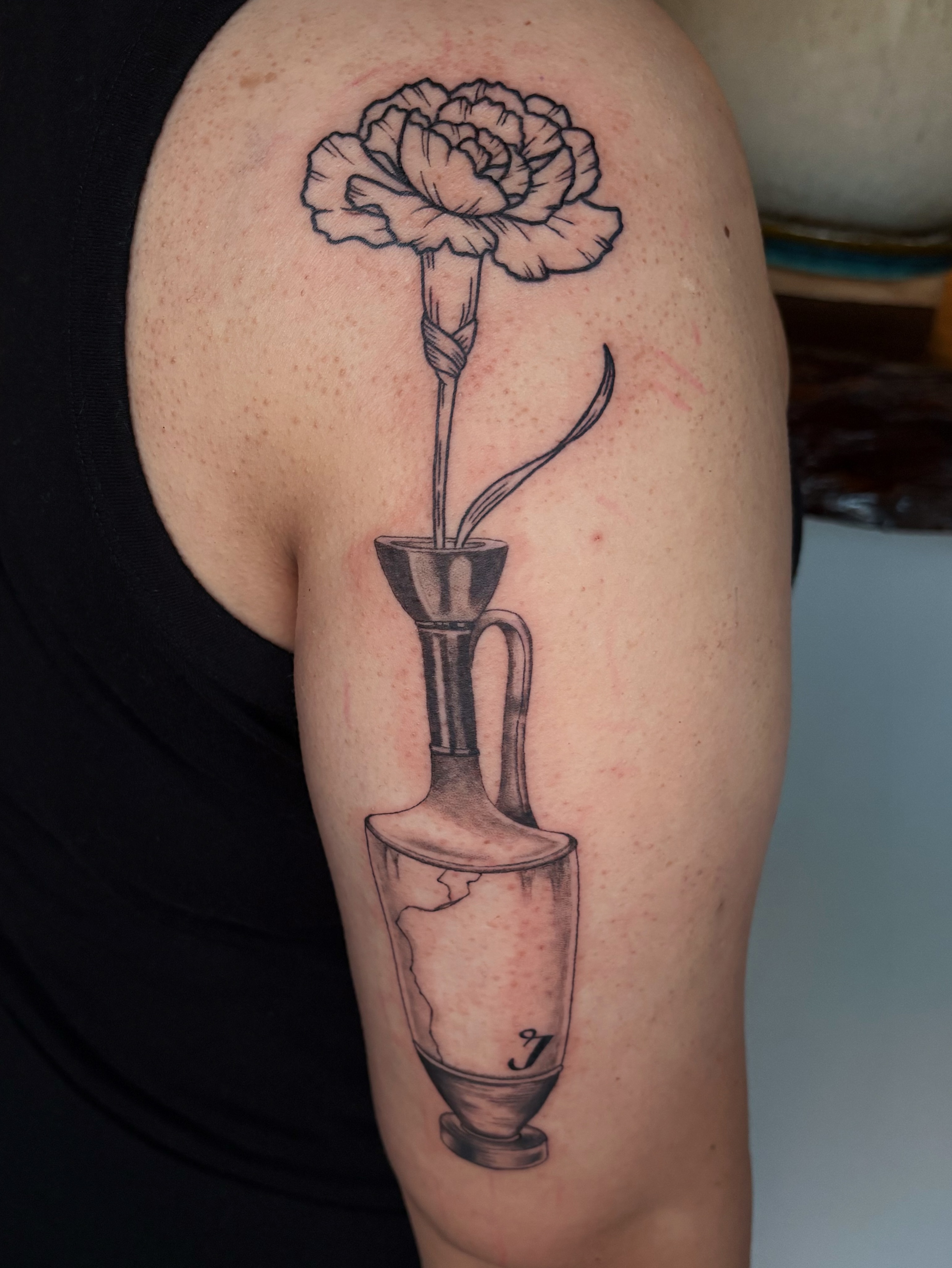 Carnation in vase black and grey tattoo on the upper arm by Abigail, San Francisco, California