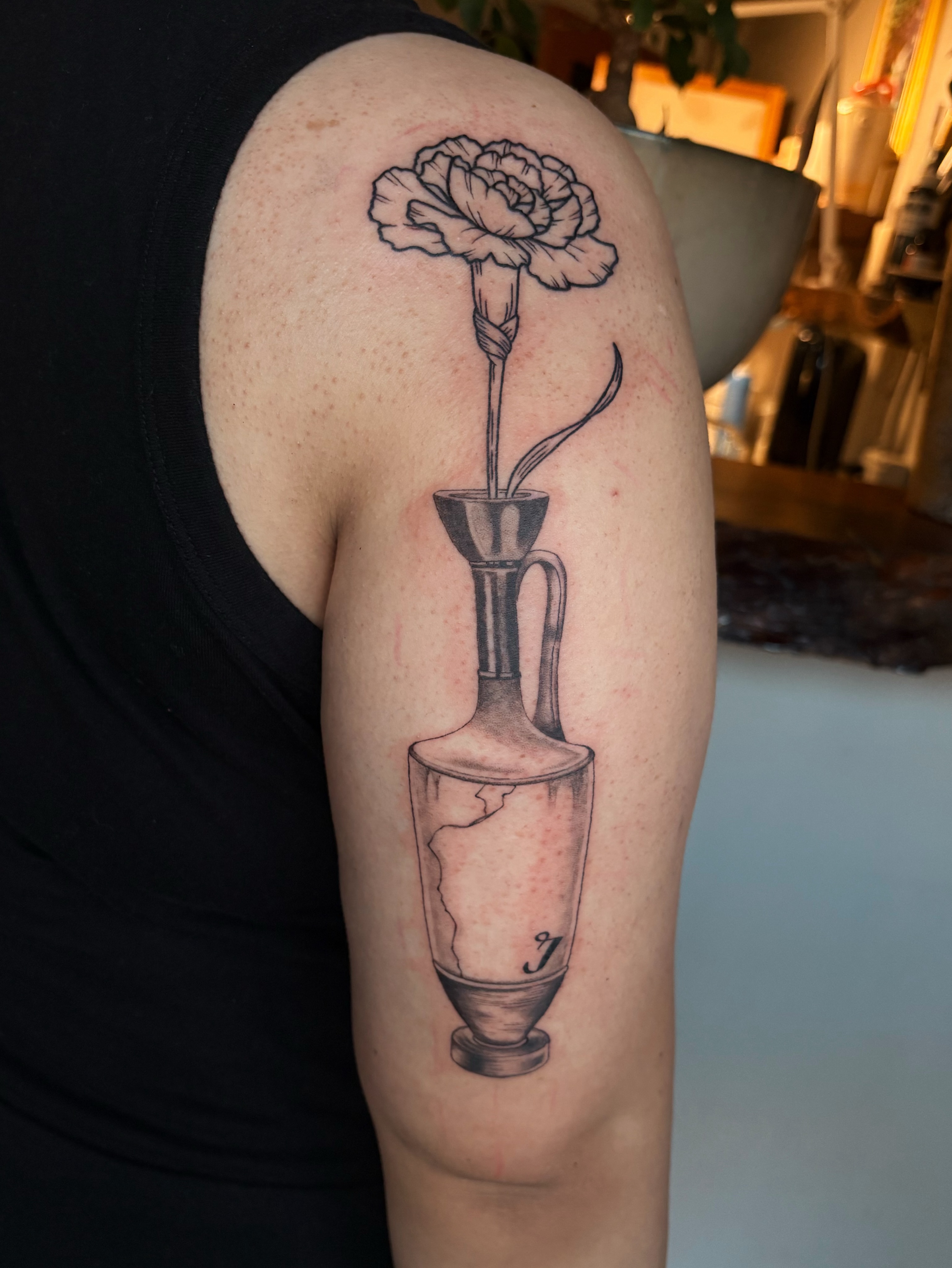 Flower in vase black and grey tattoo on the upper arm by Abigail, San Francisco, California