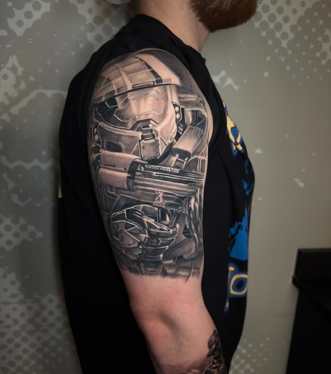 Master Chief helmet and weapon realism tattoo on the upper arm by Charlotte Tattoo Artist