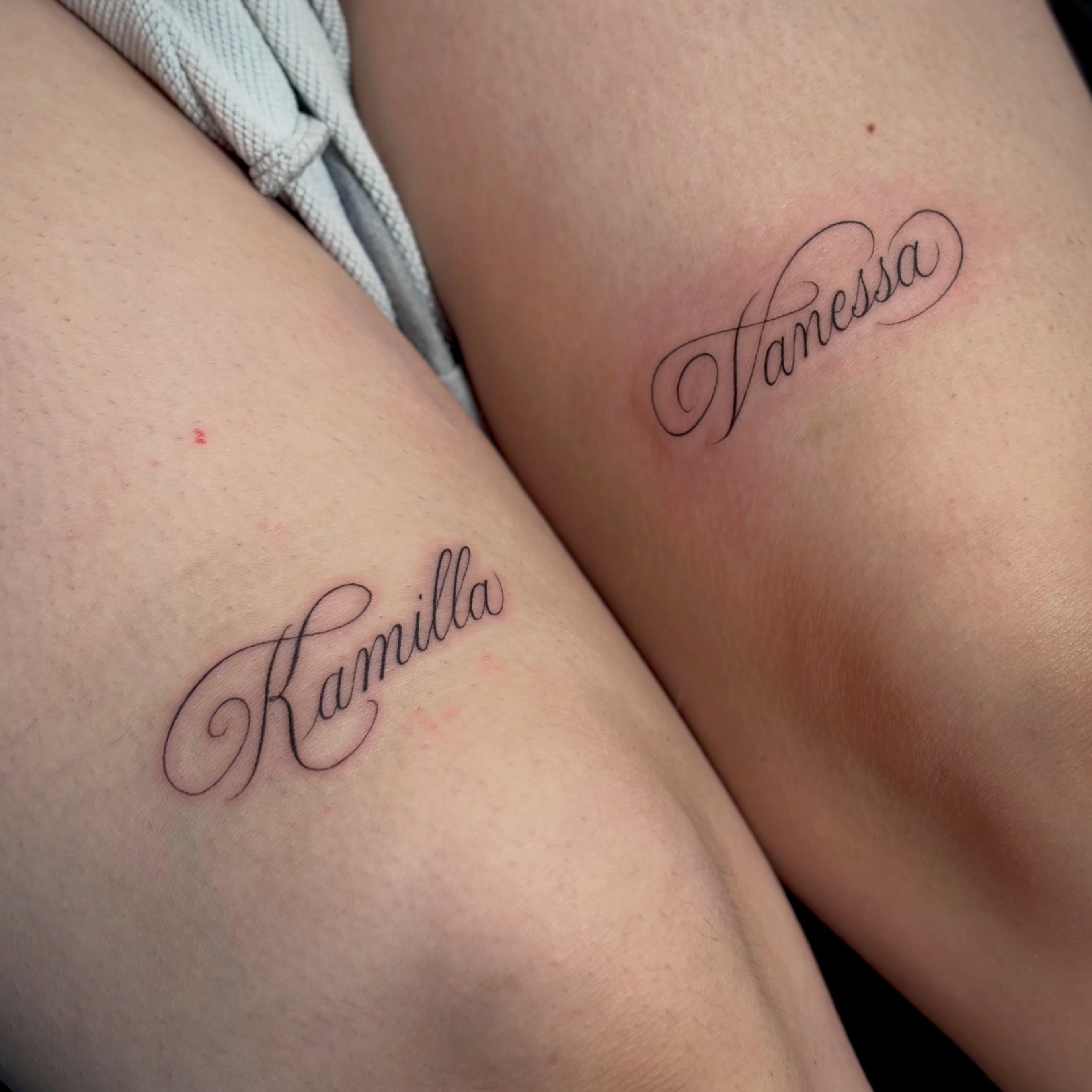 Names lettering script tattoo on the forearm by Victoria Lamorte