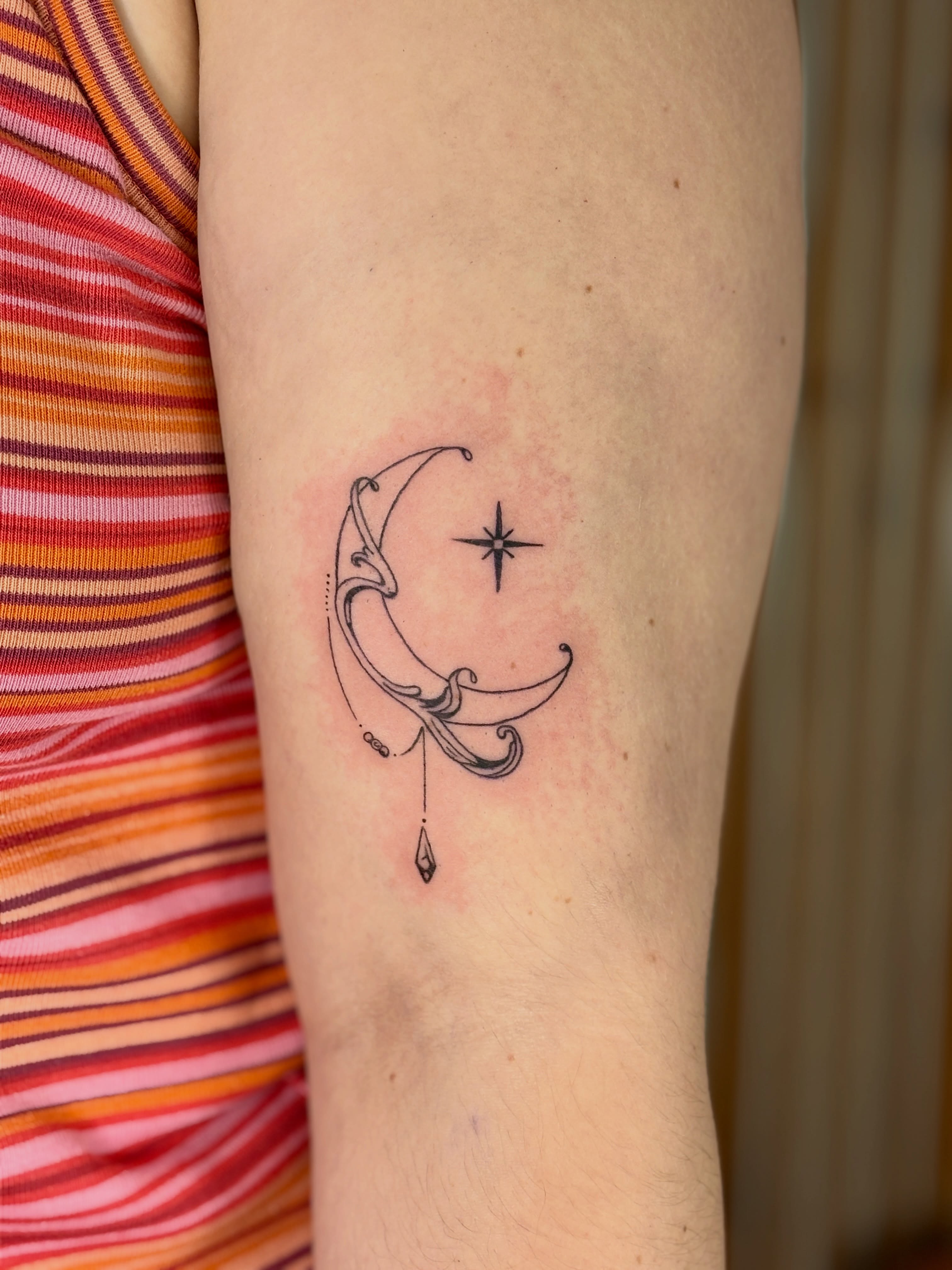 Moon and star fine line tattoo on the forearm by Maddie