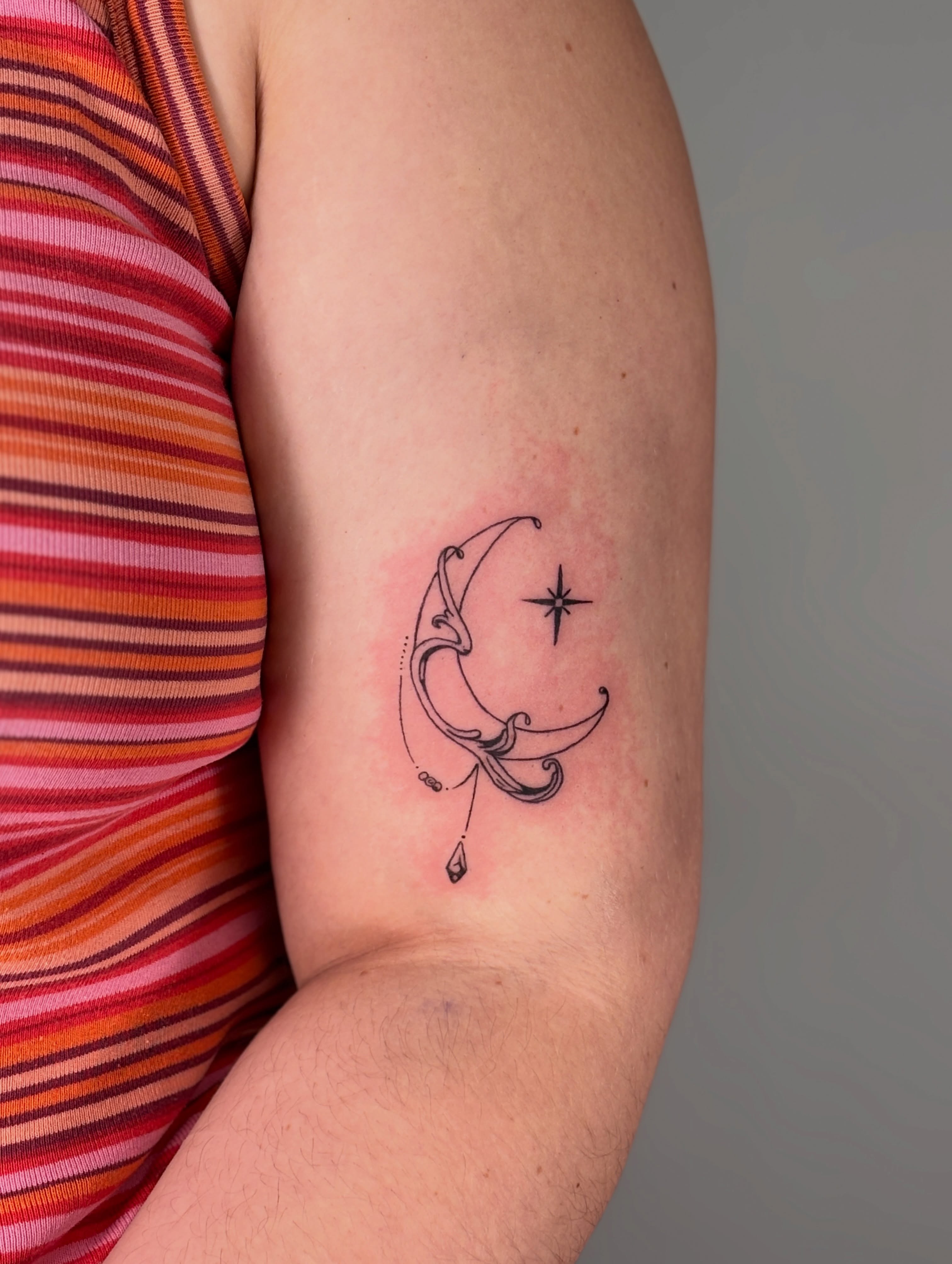 Moon and star fine line tattoo on the forearm by Maddie