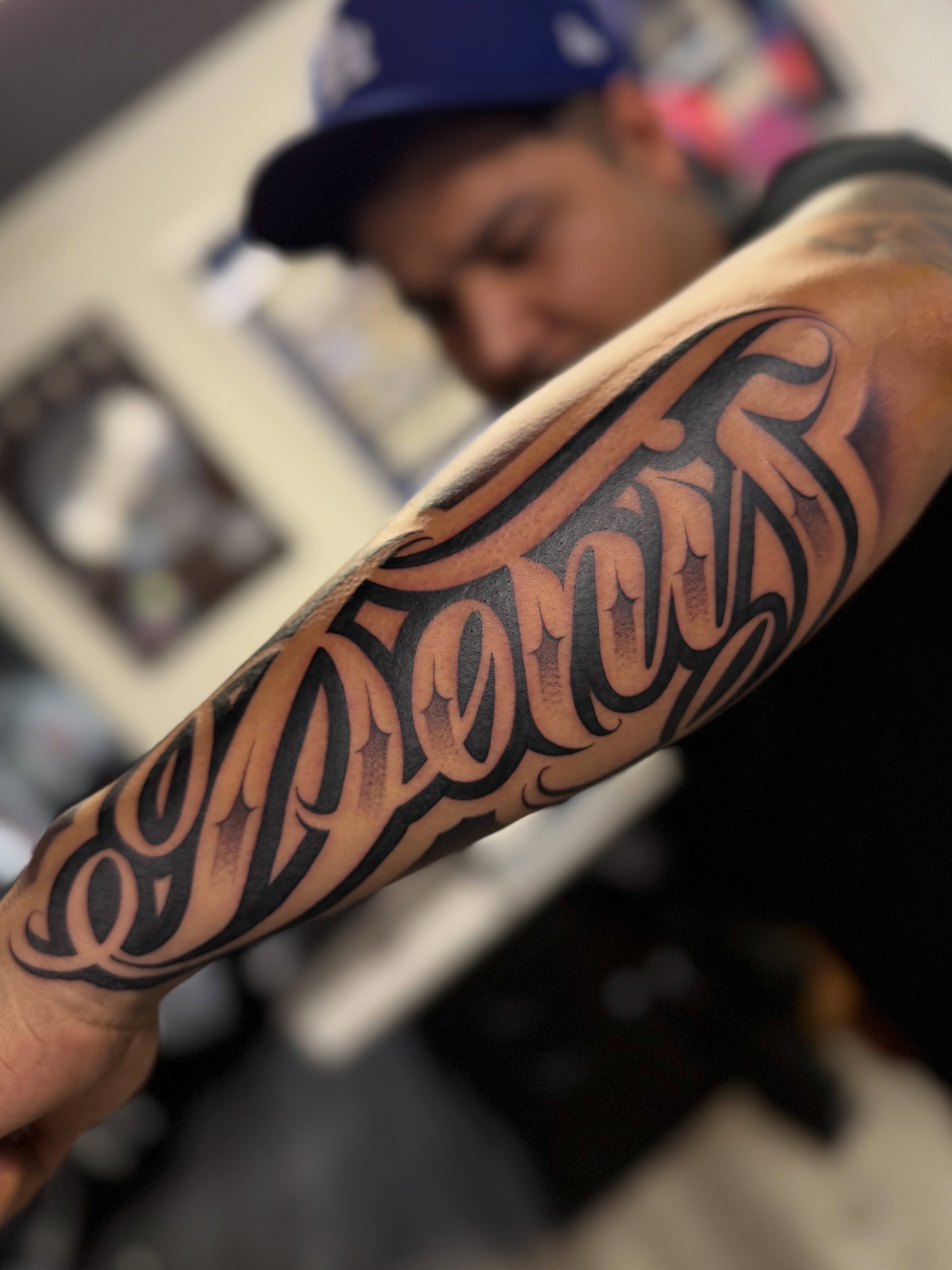 Script lettering lettering script tattoo on the forearm by Rocky G Inkz LLC
