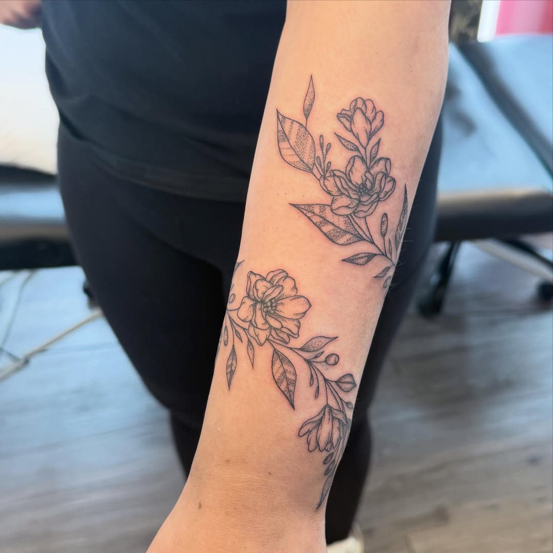 Floral arrangement black and grey tattoo on the forearm by ✨olivia