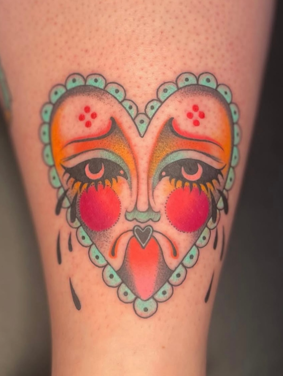 Heart with face American traditional tattoo on the thigh by Eryn, Portland, Oregon