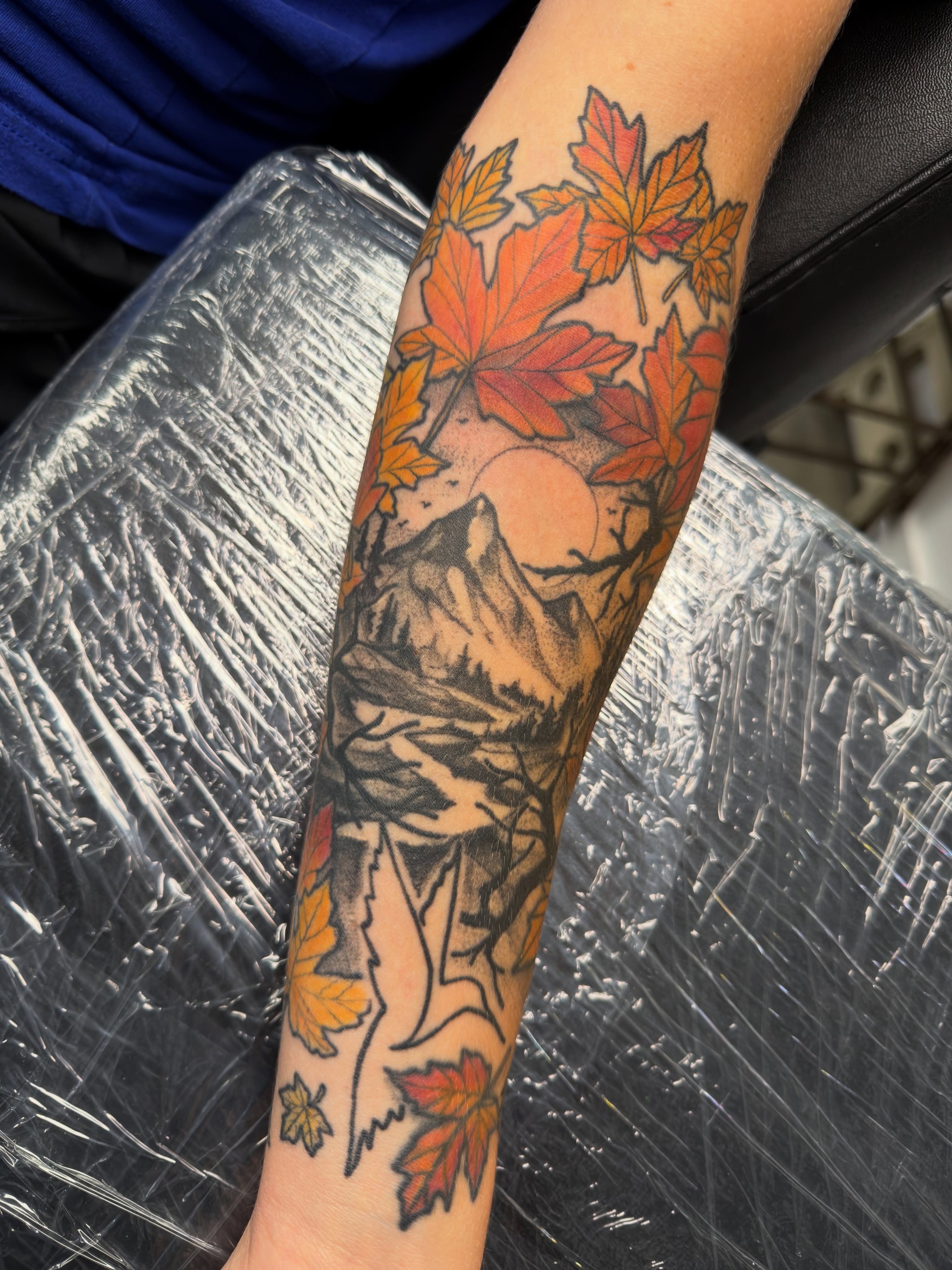 Autumn landscape realism tattoo on the forearm by Christopher Layman