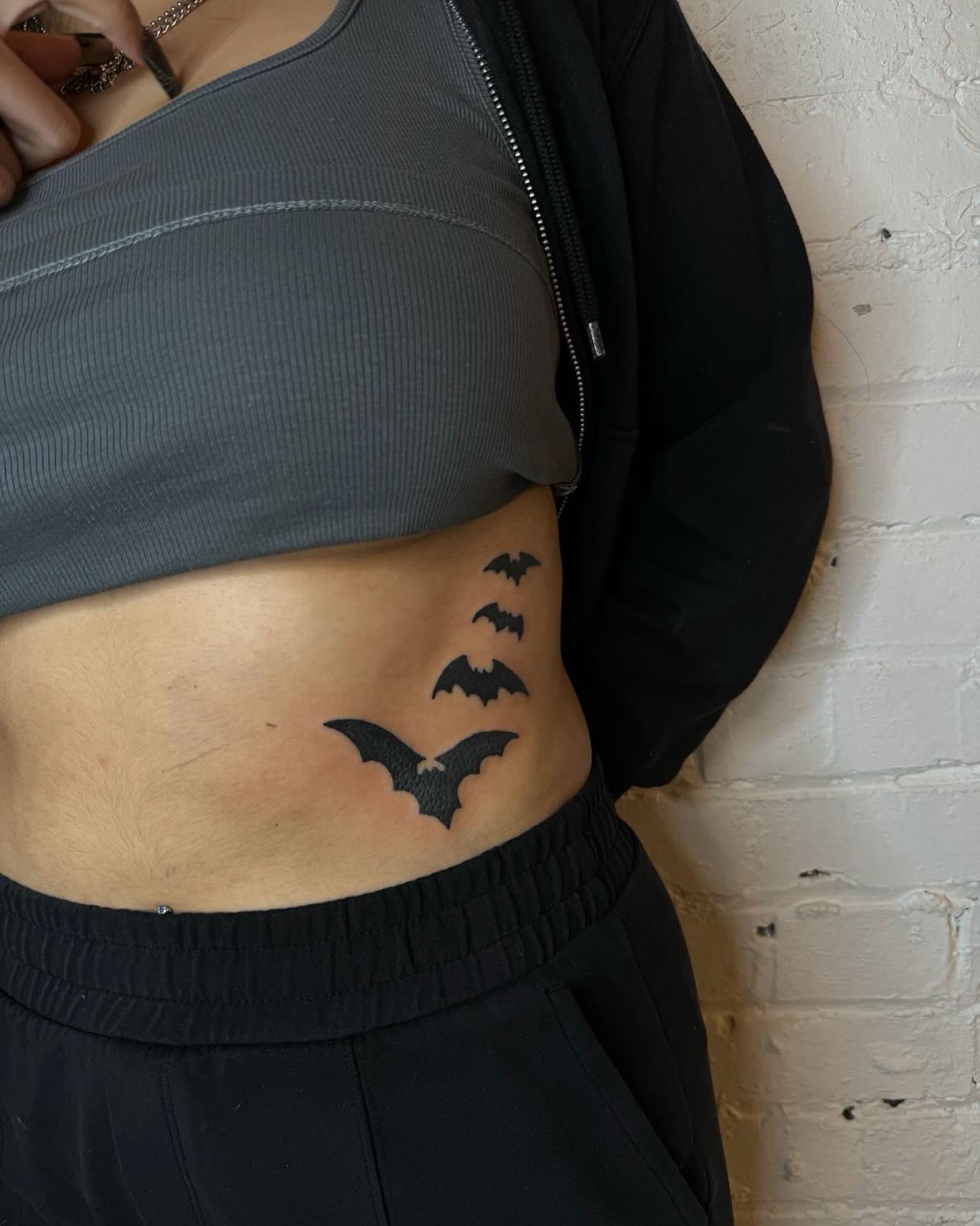 Bat black and grey tattoo on the ribs by Dennis Patterson