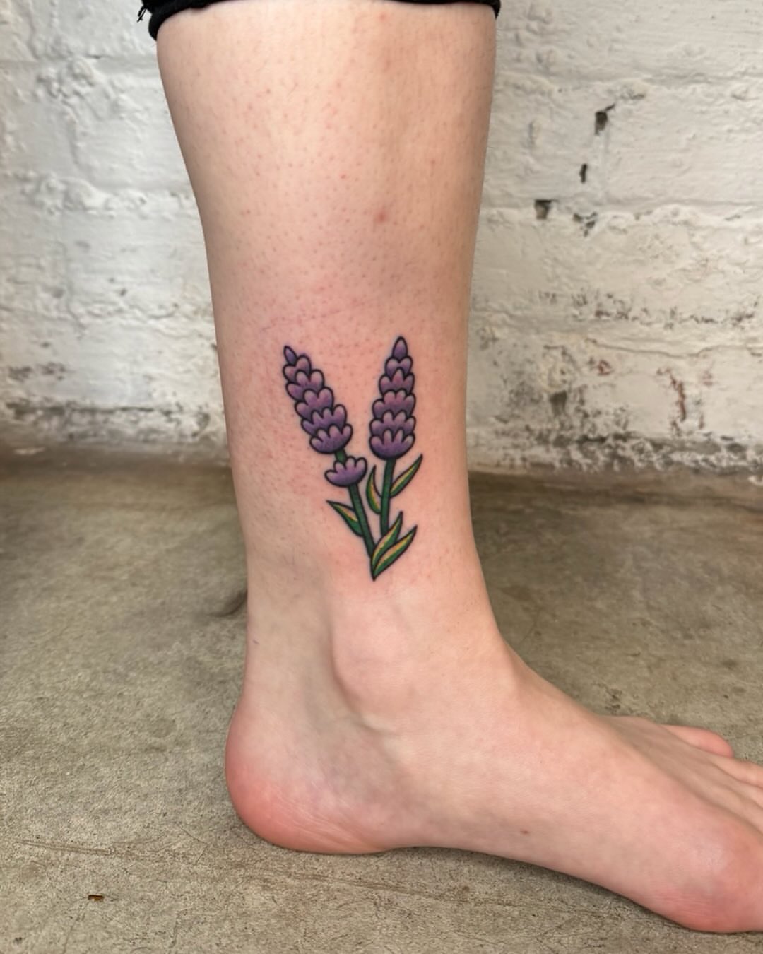 Lavender flowers dotwork tattoo on the calf by Dennis Patterson