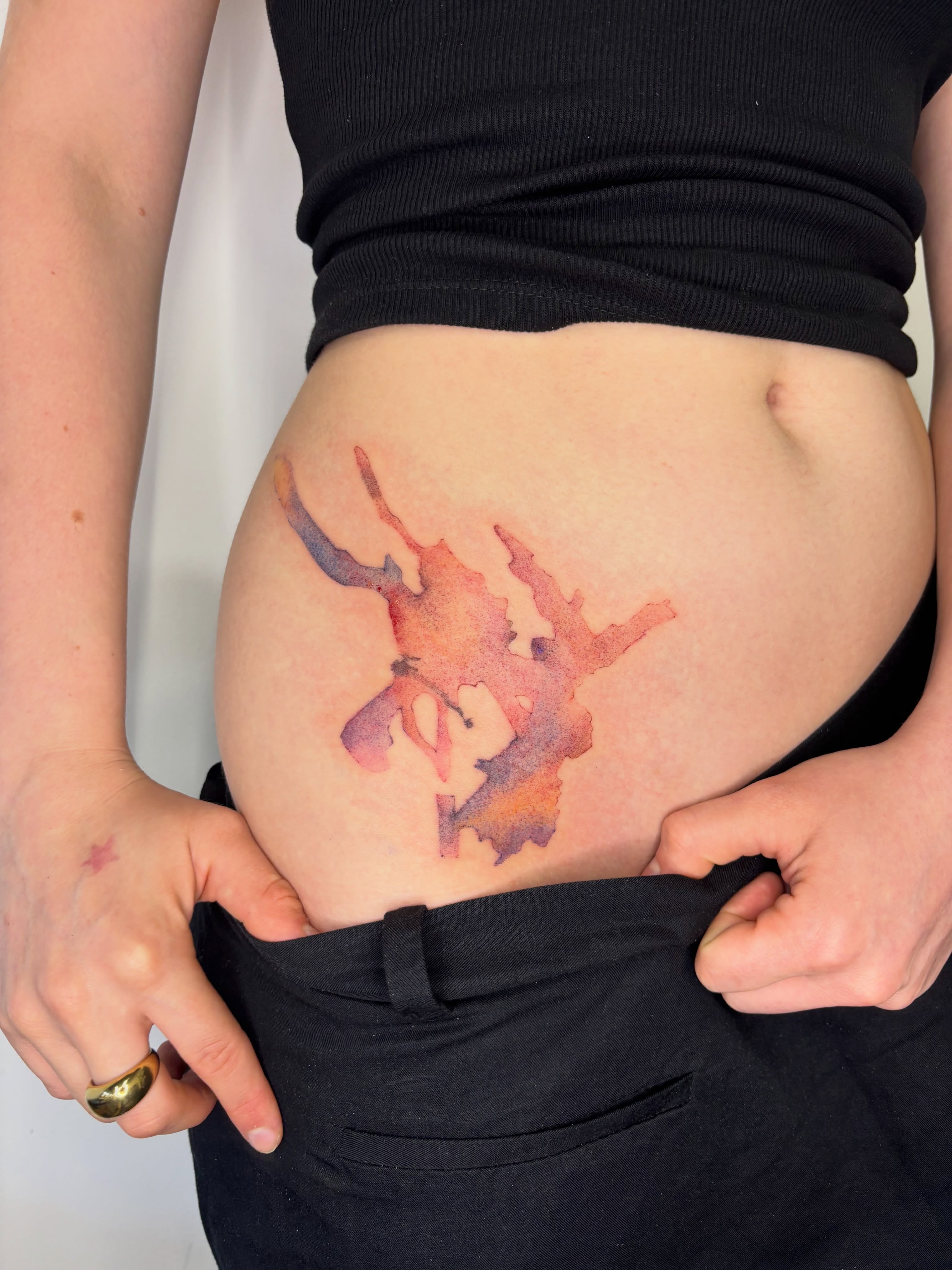 Abstract shape watercolor tattoo on the torso by @havefun_tattoo