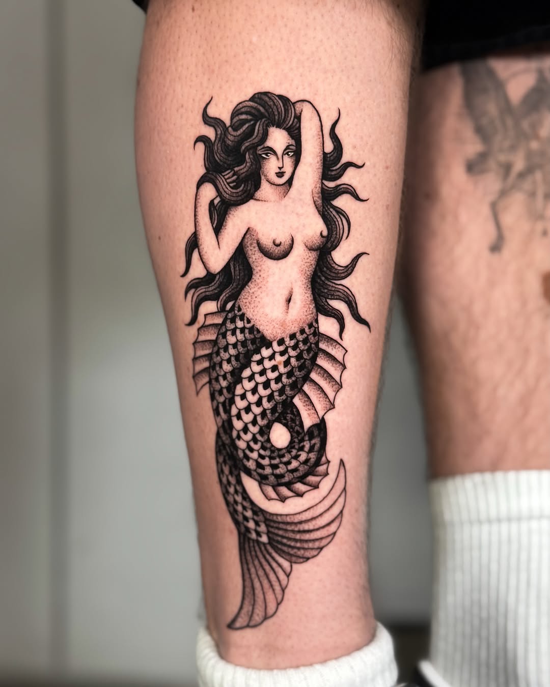 Mermaid dotwork tattoo on the calf by Jae Traditional Tattoo