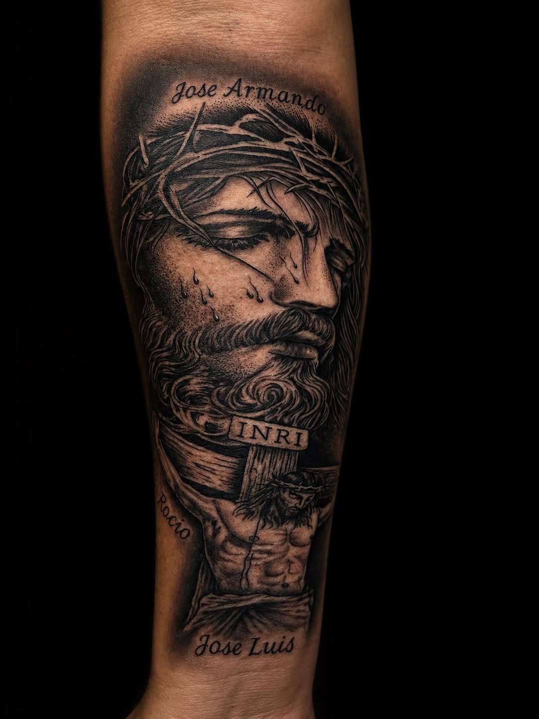Jesus Christ on the cross Chicano tattoo on the forearm by Rico Rosario
