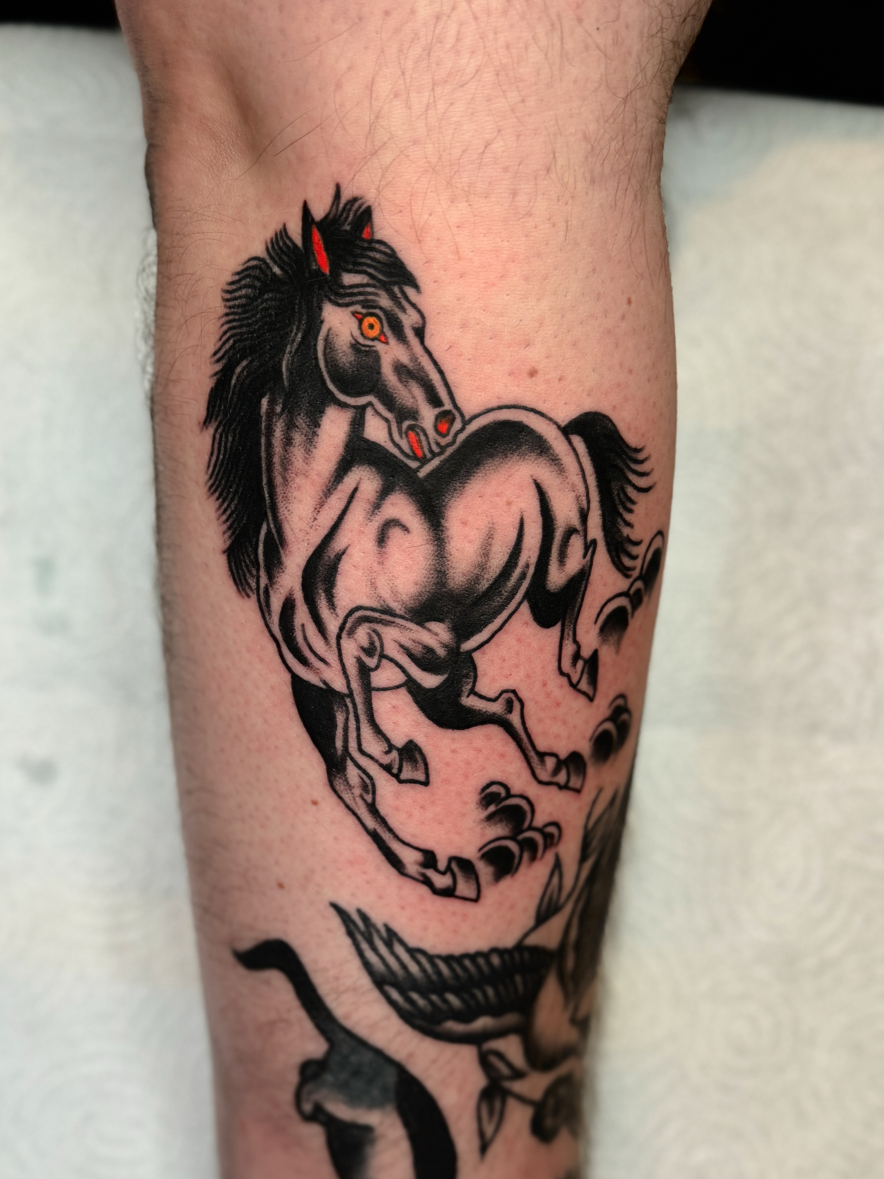 Galloping horse black and grey tattoo on the forearm by Allie Barringer
