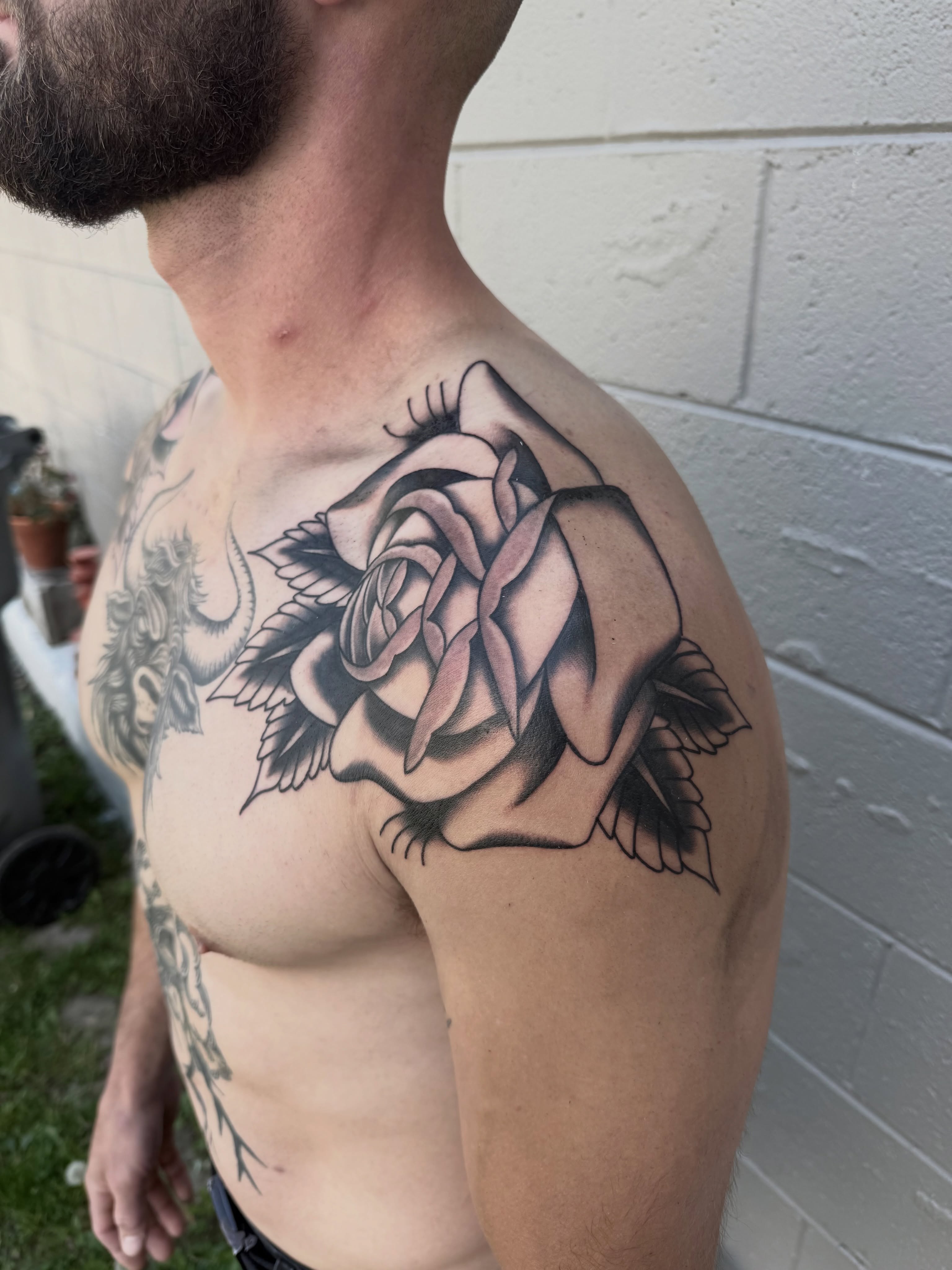 Rose black and grey tattoo on the shoulder by Joe Weber, Monona, Wisconsin