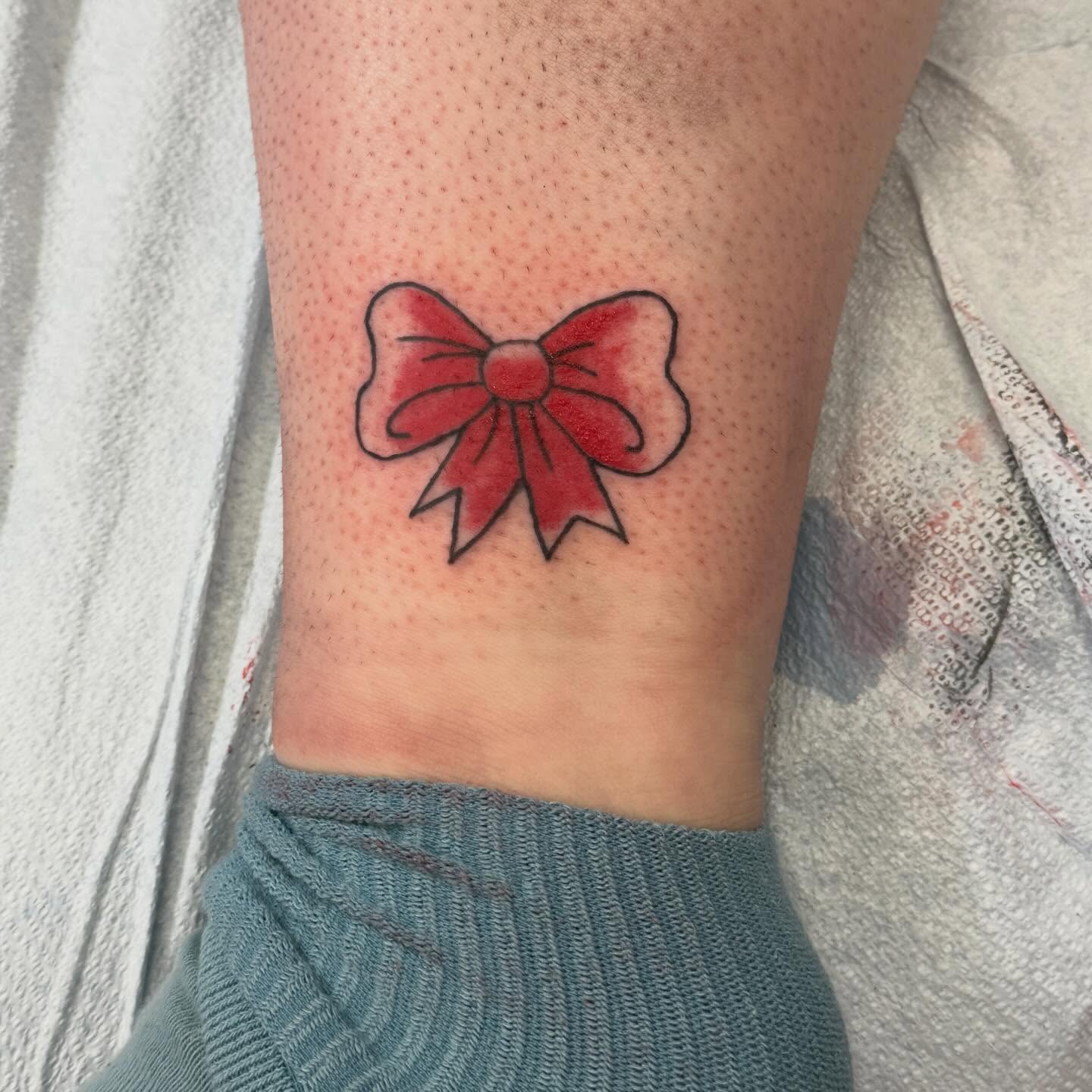 Red bow dotwork tattoo on the forearm by Tomfoolery