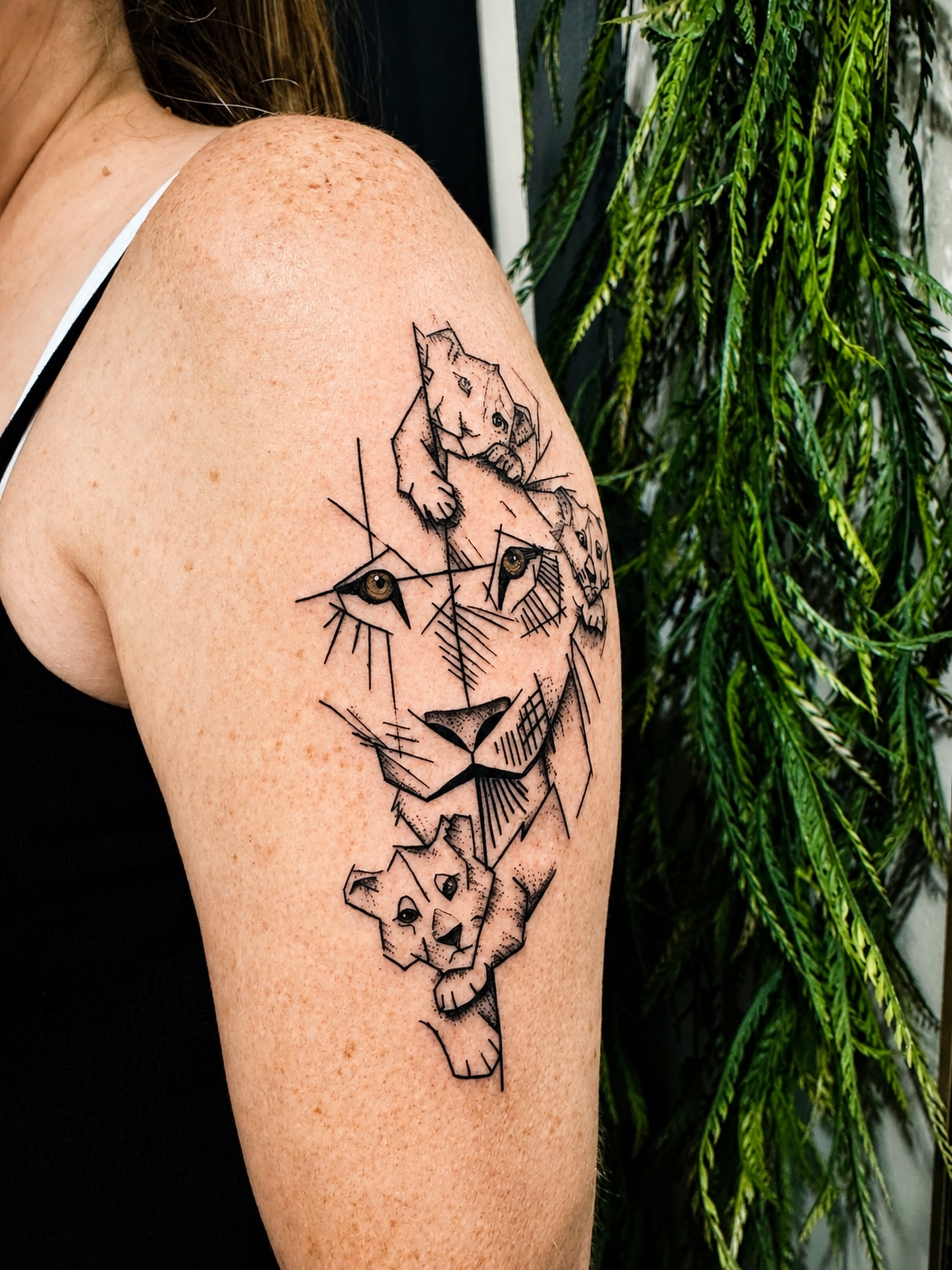 Lion family geometric tattoo on the shoulder by JAmy Winters