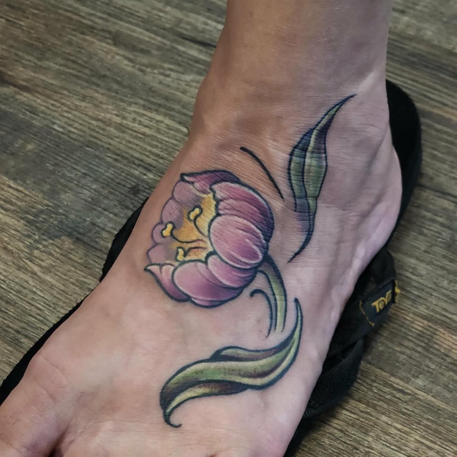 Purple tulip watercolor tattoo on the foot by Trista Bettfreund (Birdy)