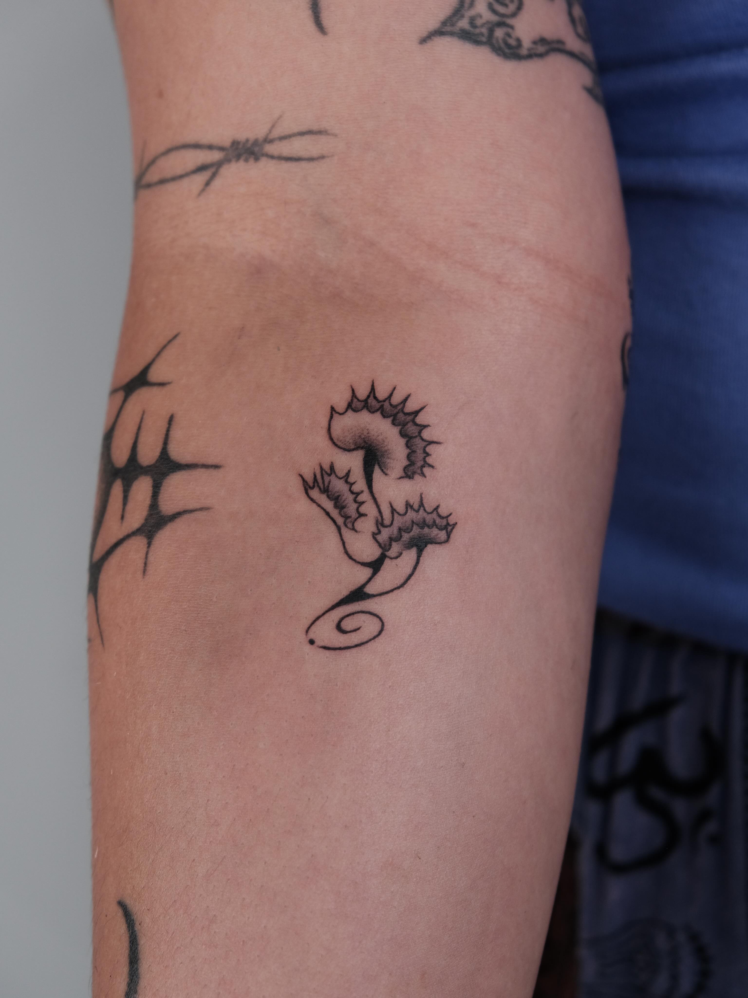 Seahorse black and grey tattoo on the forearm by Elana Hites