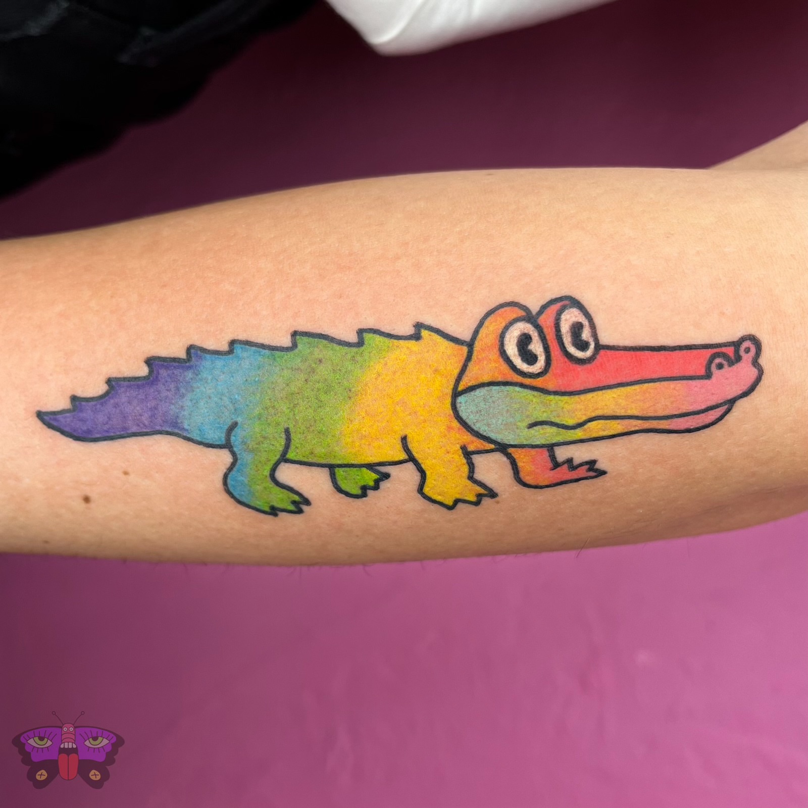 Rainbow crocodile new school tattoo on the forearm by Jess Koala, San Francisco, California