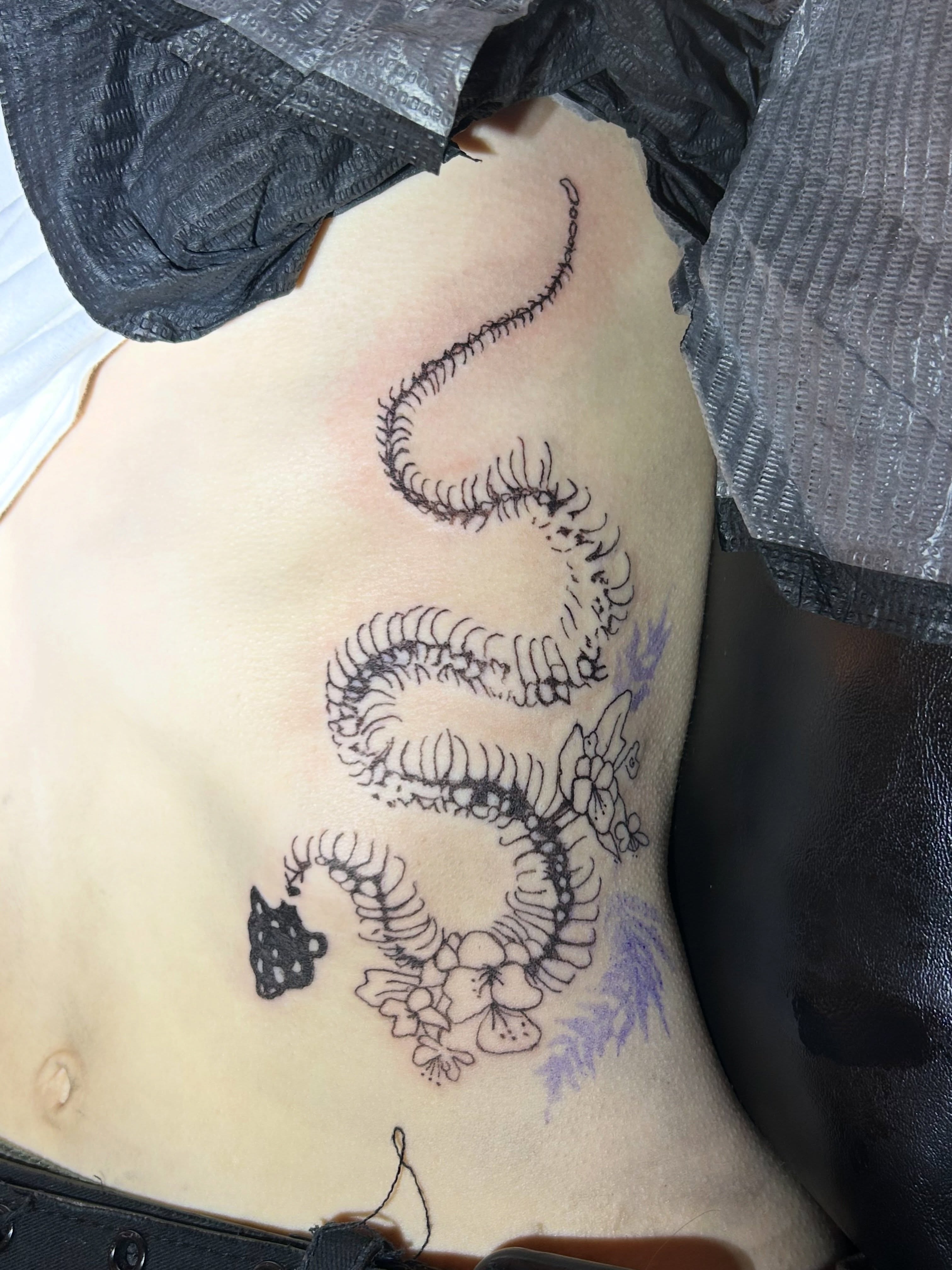 Snake and flowers black and grey tattoo on the chest by Mattie Robinson