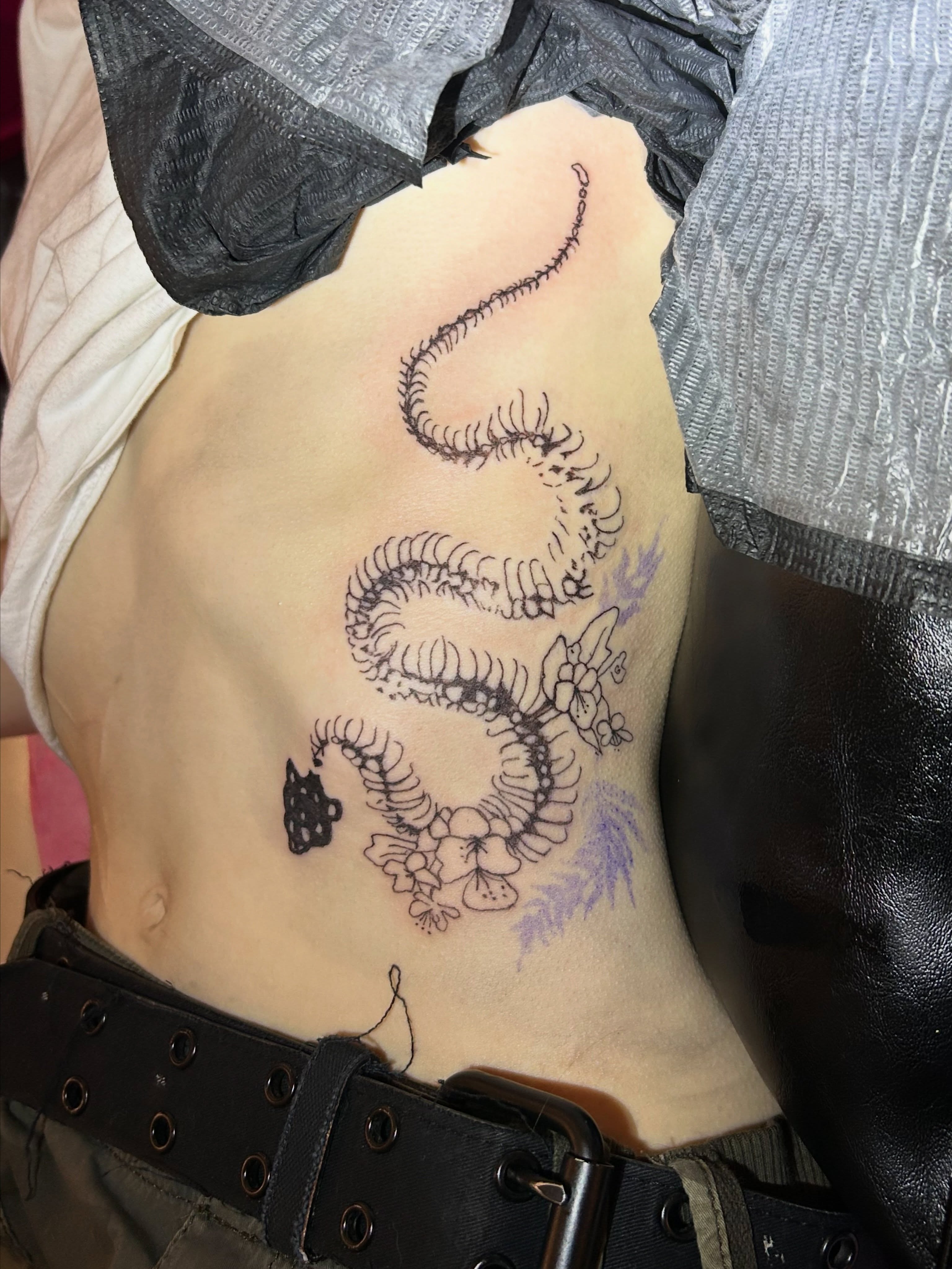 Scorpion and flowers black and grey tattoo on the torso by Mattie Robinson