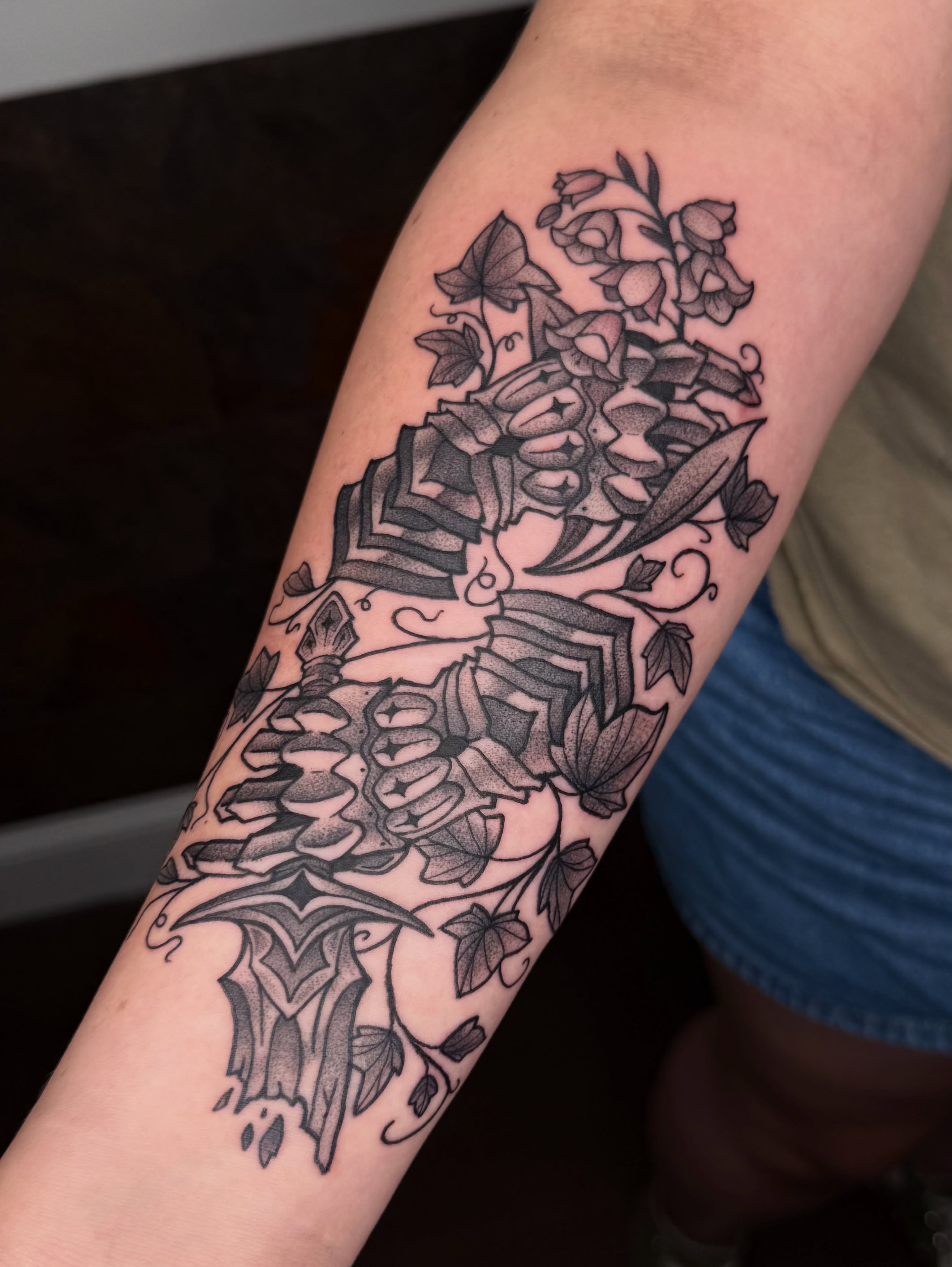Floral arrangement geometric tattoo on the forearm by Jezza Munson