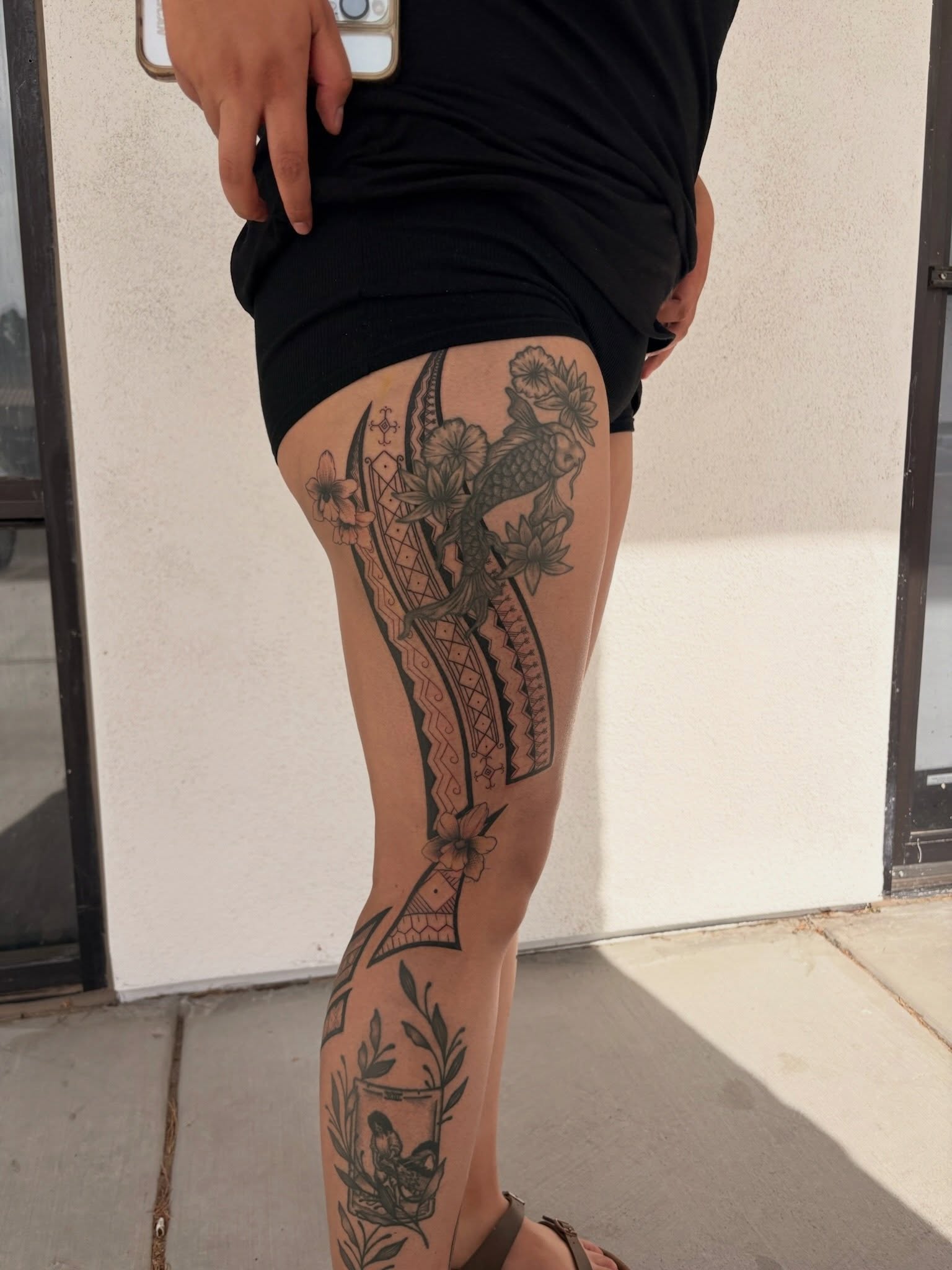 Floral and bird design black and grey tattoo on the thigh by tati 🇬🇺🇵🇭