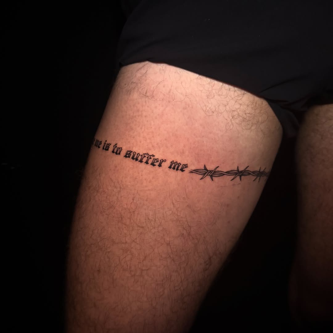 Barbed wire black and grey tattoo on the thigh by Lauren B