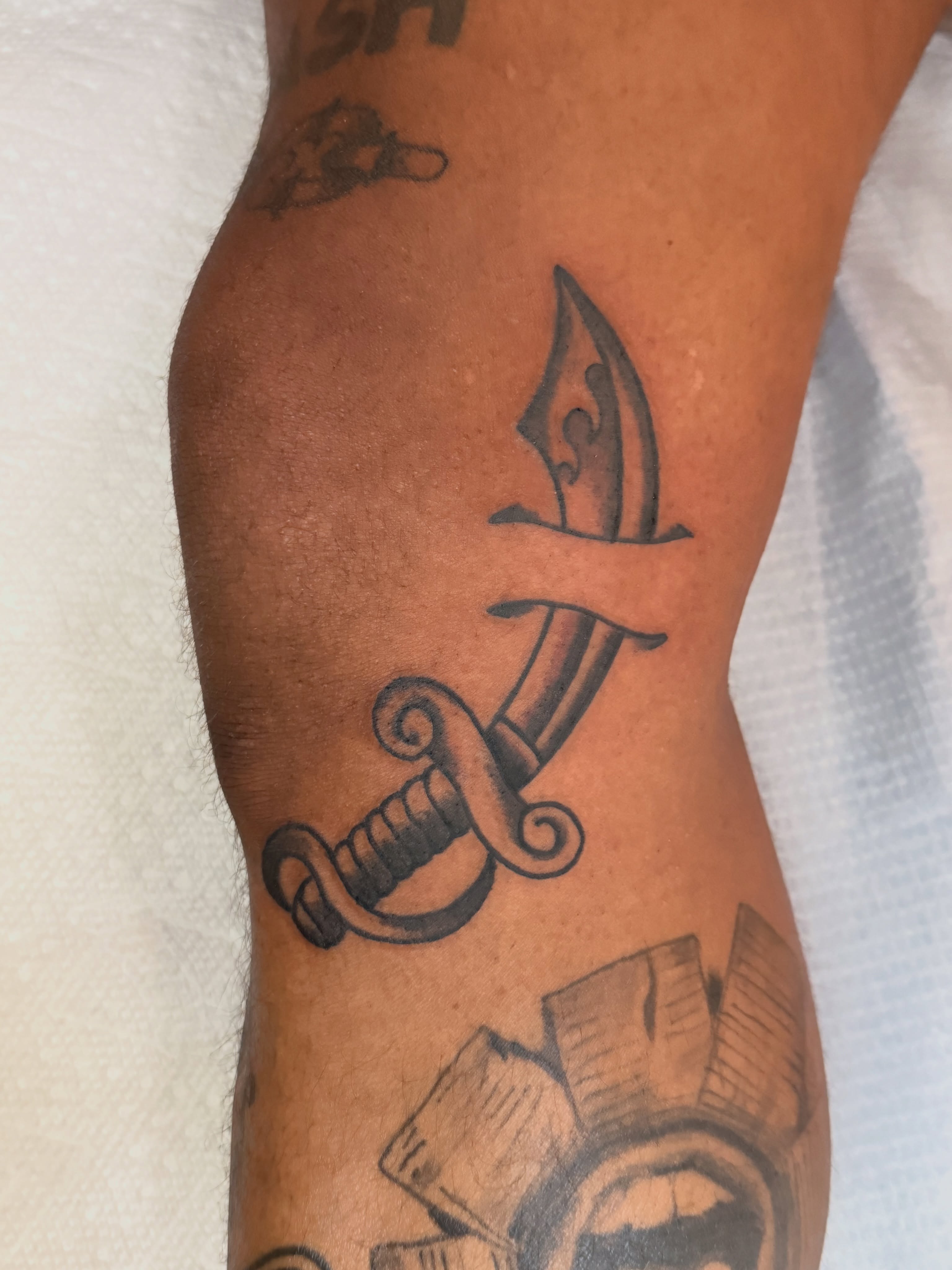 Sword and sheath black and grey tattoo on the forearm by Andre Guerra
