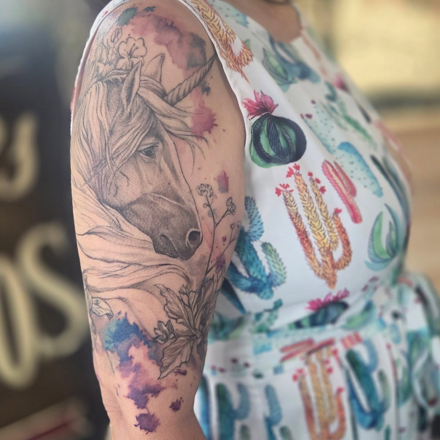 Unicorn realism tattoo on the upper arm by Molly DeSmedt