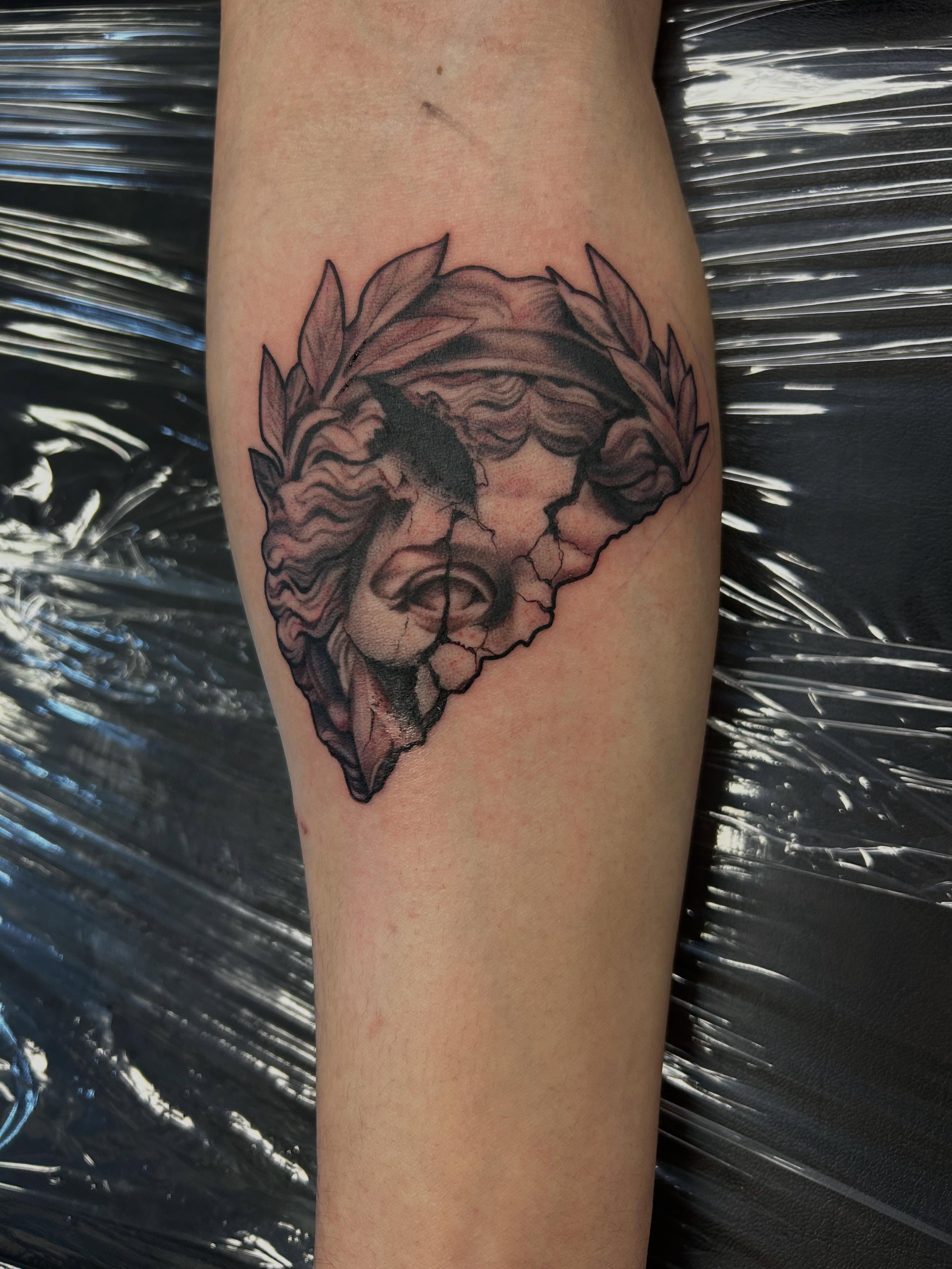 Wreath realism tattoo on the forearm by Mayhem Andrews