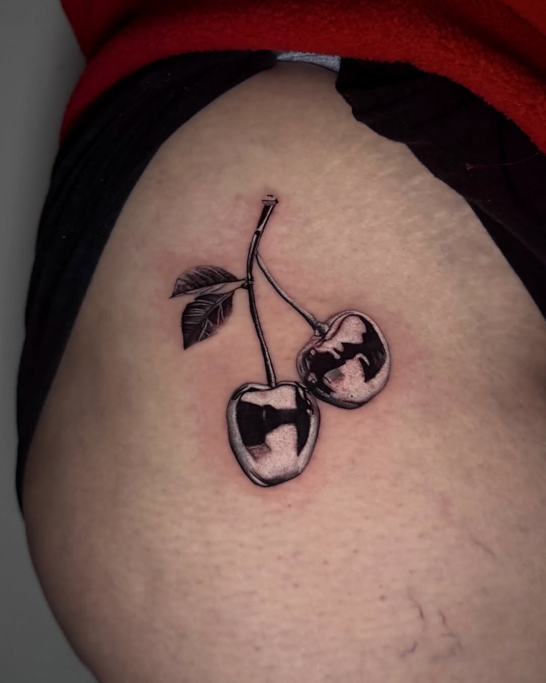 Cherries realism tattoo on the thigh by Giovanni Rodriguez, Eastpointe, Michigan