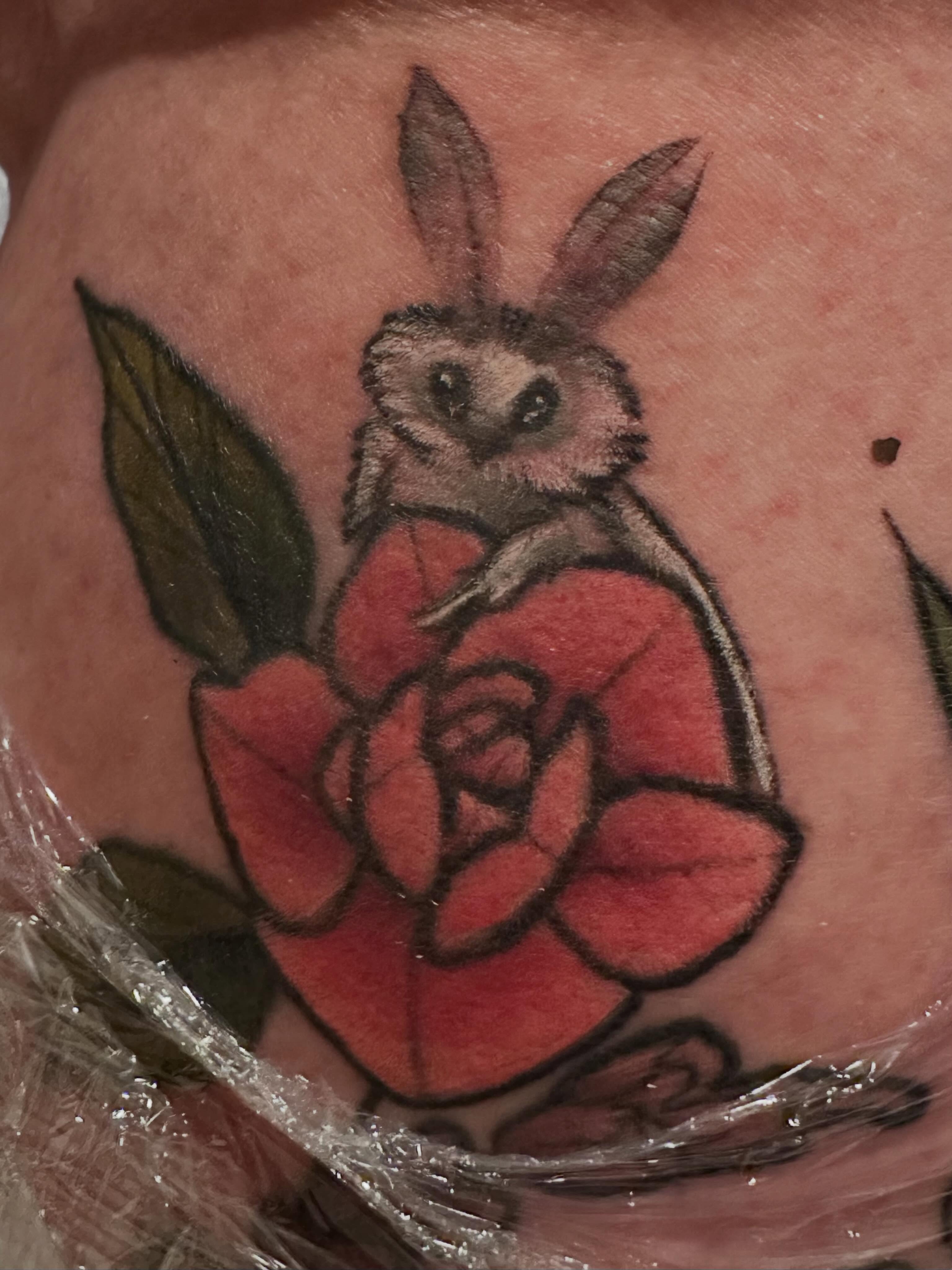 Rabbit and rose American traditional tattoo on the torso by Katie Hutchins, Dayton, Ohio