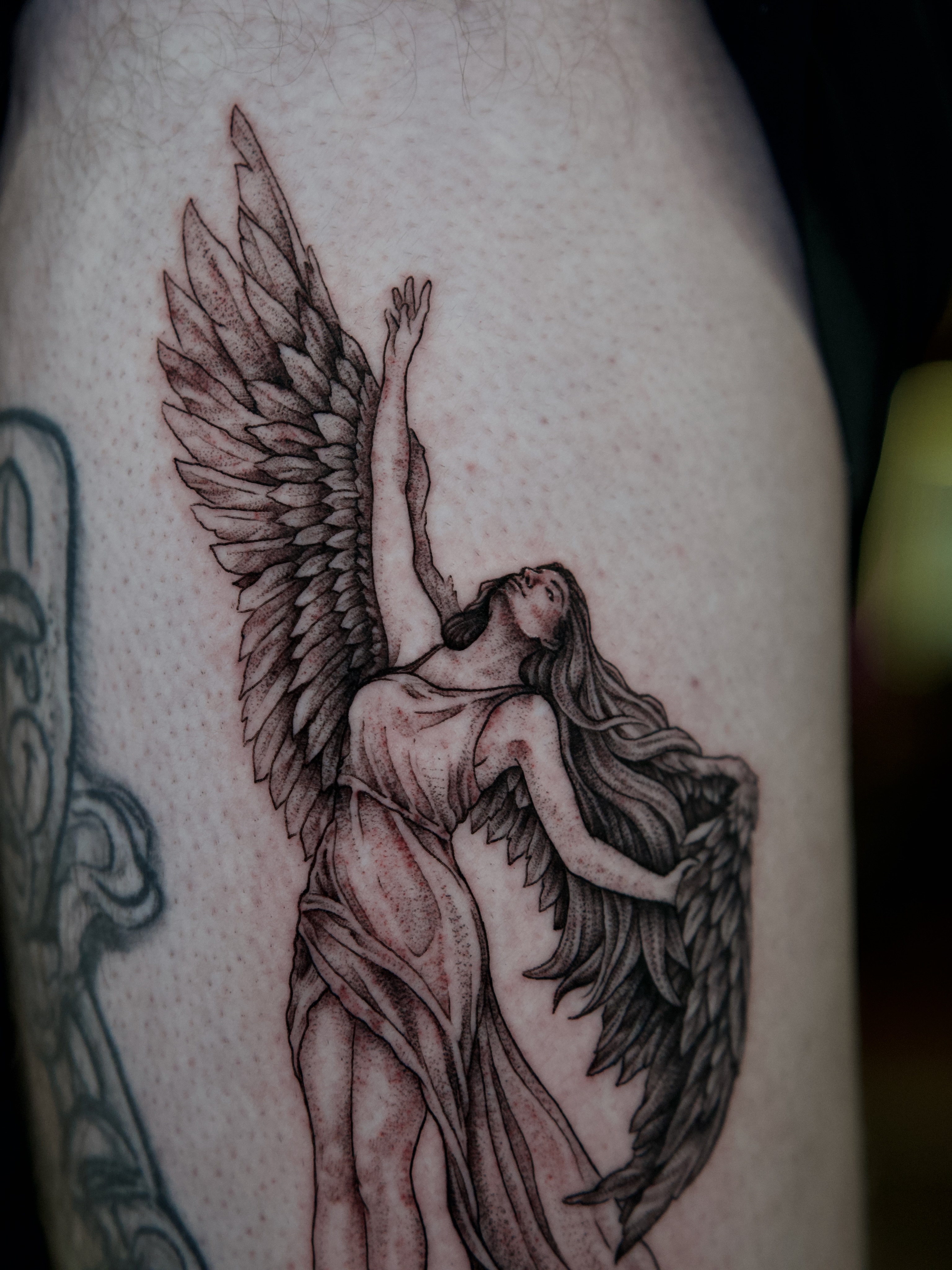 Angel dotwork tattoo on the thigh by Raven Wood