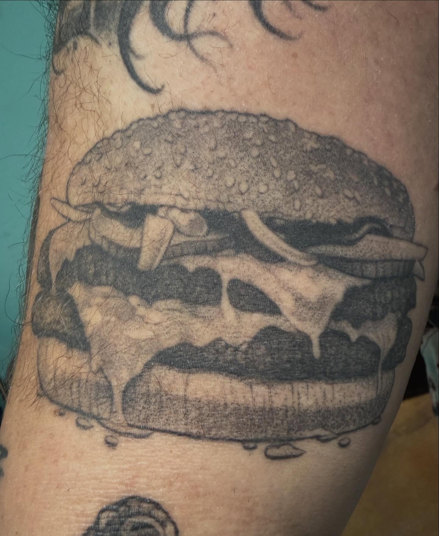 Hamburger black and grey tattoo on the forearm by Austin Tattoo Artist