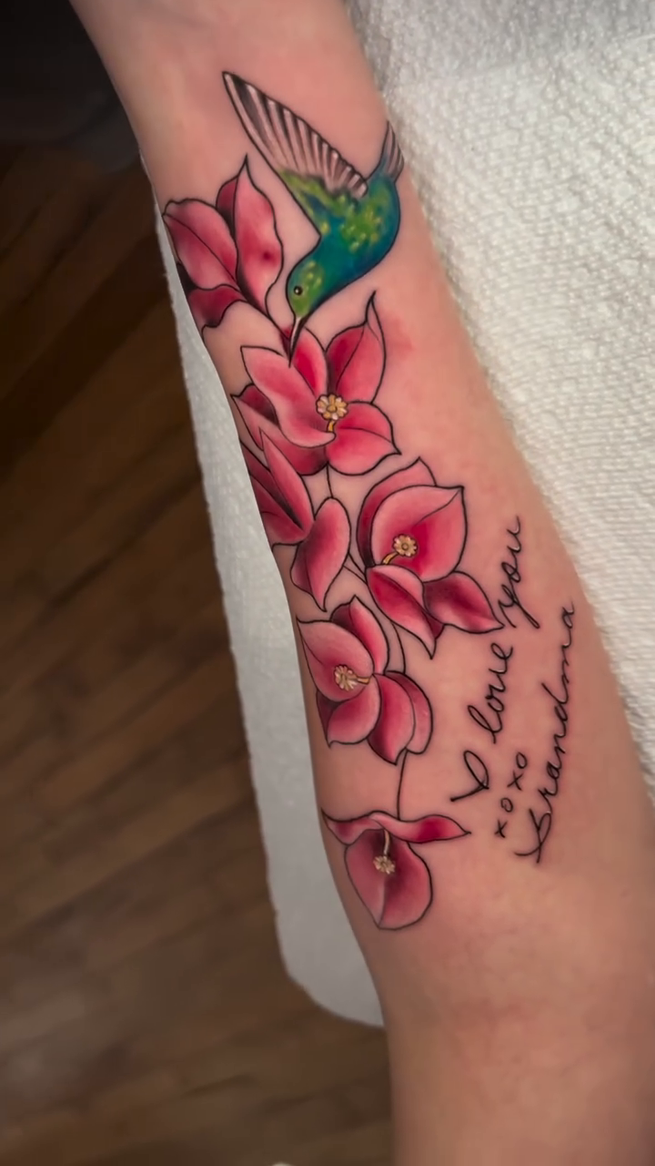 Hummingbird and flowers with script watercolor tattoo on the forearm by High Vibrations