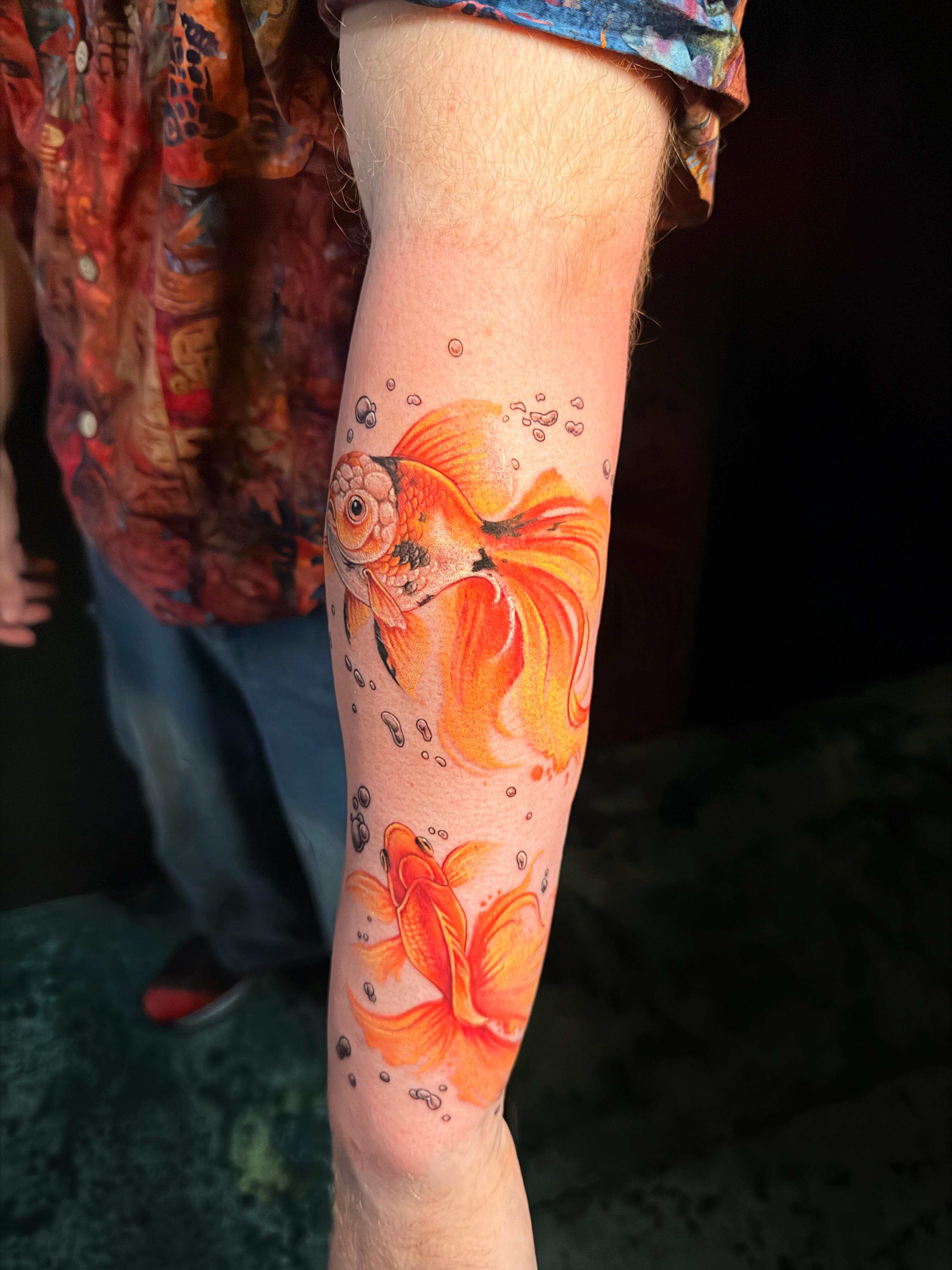 Goldfish and lotus realism tattoo on the forearm by Violet Michelle Williams, Charlotte, North Carolina