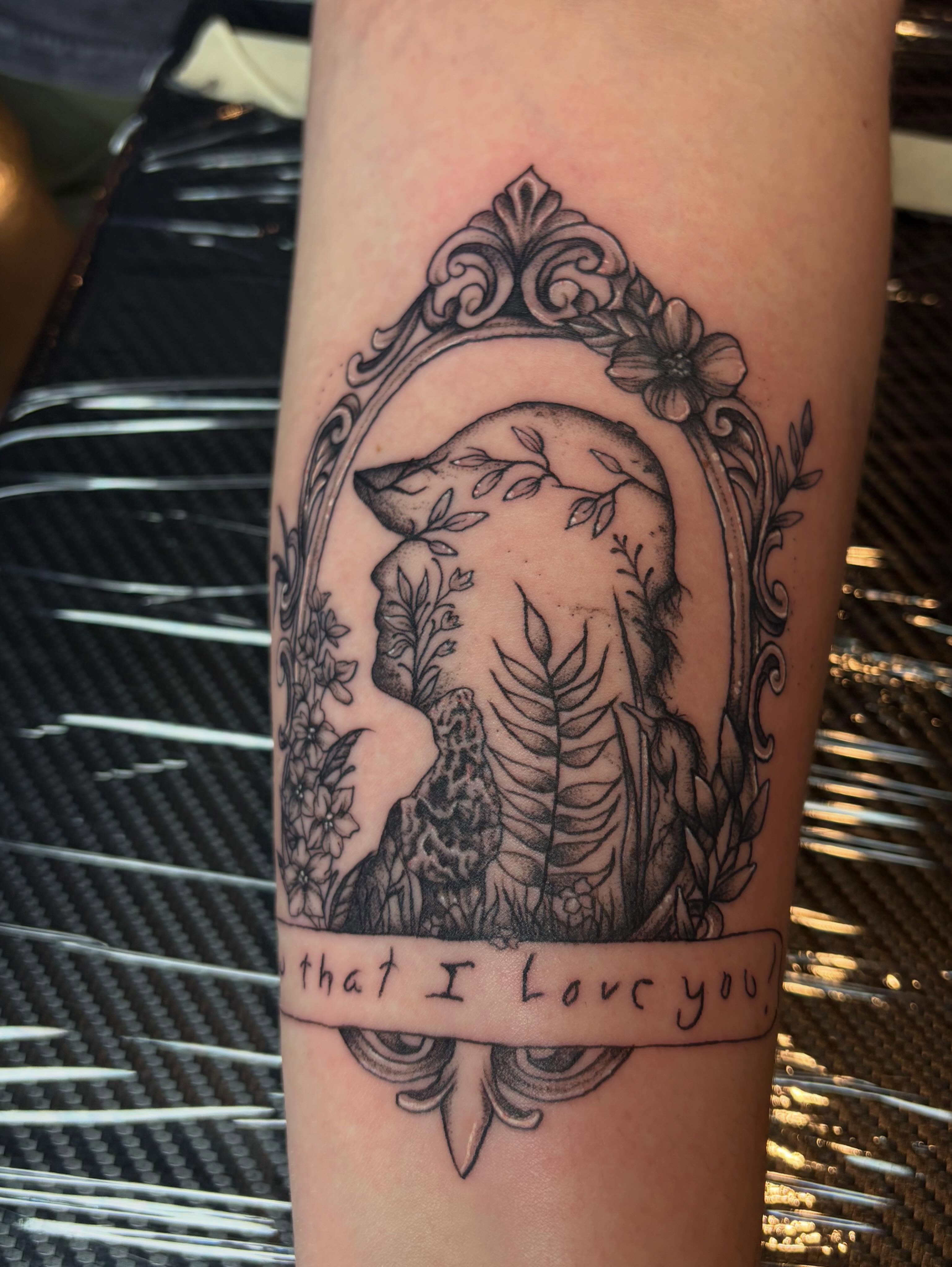 Wolf and floral frame ornamental tattoo on the forearm by destany aguilera, Davenport, Iowa