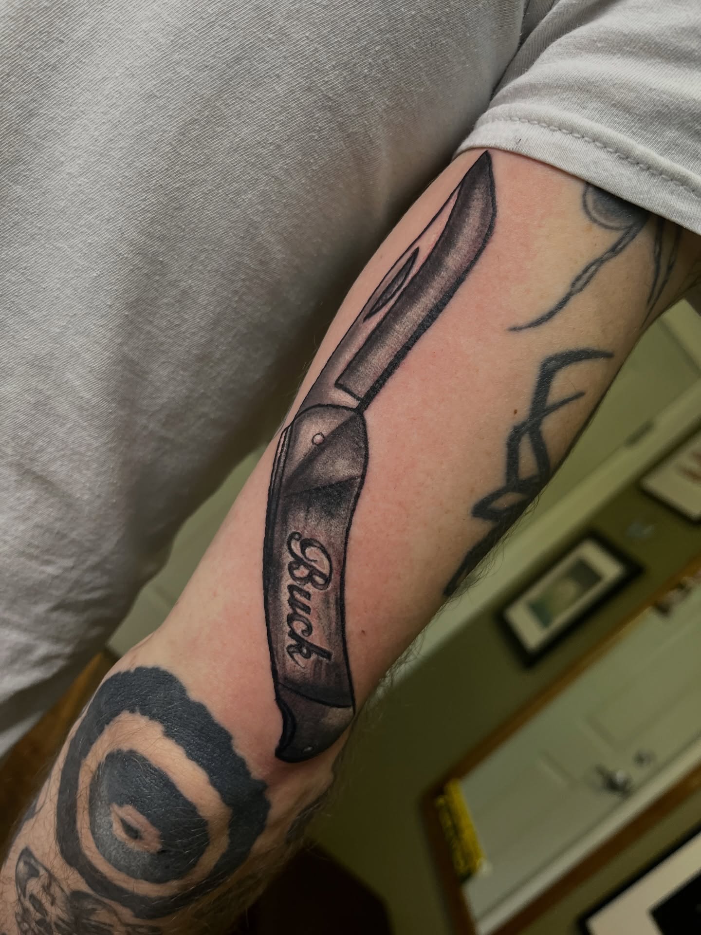 Knife black and grey tattoo on the forearm by Misha Dumois, Seattle, Washington