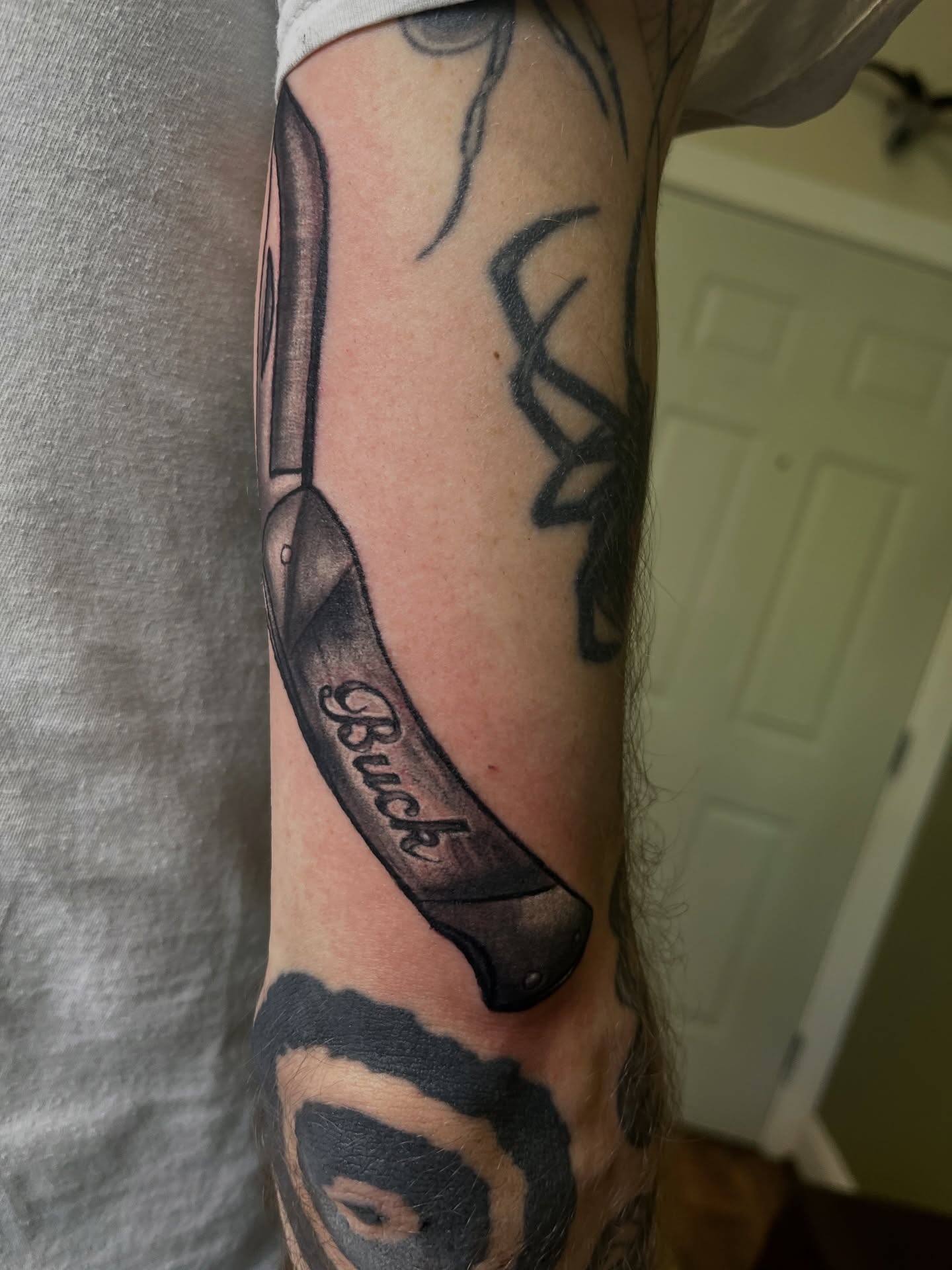 Knife black and grey tattoo on the forearm by Misha Dumois, Seattle, Washington