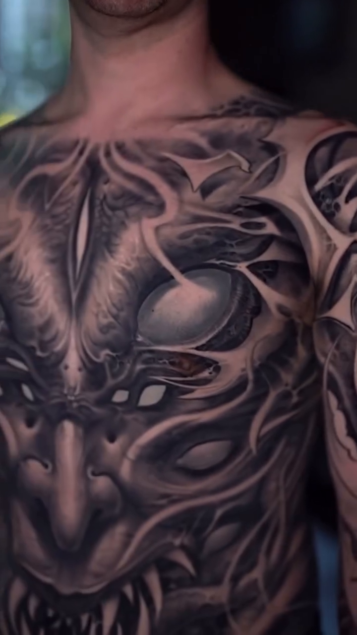 Biomechanical demon chest and arm tattoo dark art tattoo on the chest by Victor Portugal Tattoo