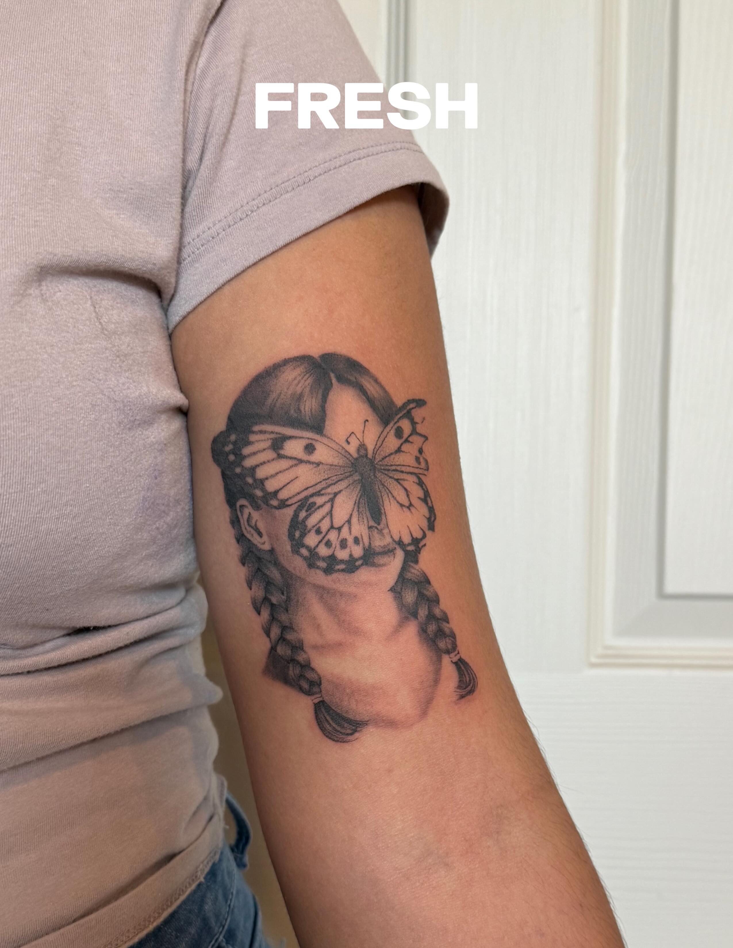 Woman with butterfly realism tattoo on the forearm by Julianna