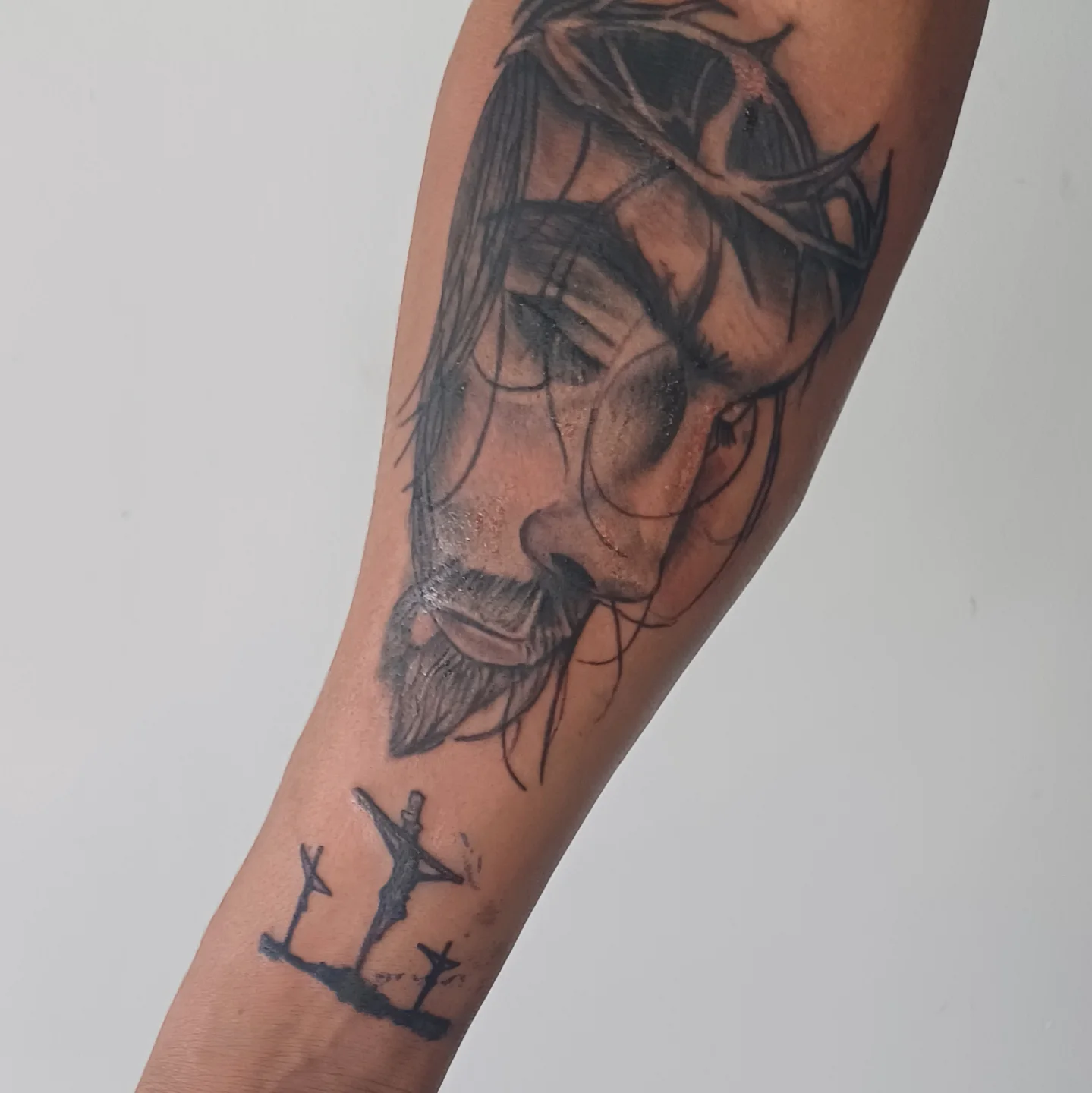 Jesus Christ realism tattoo on the forearm by Miami Beach Tattoo Artist